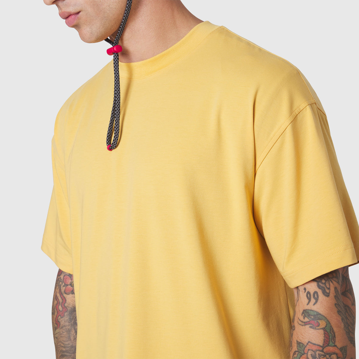 Supima Ice-Skin Reversible Tee in amber yellow, worn by model showing front view