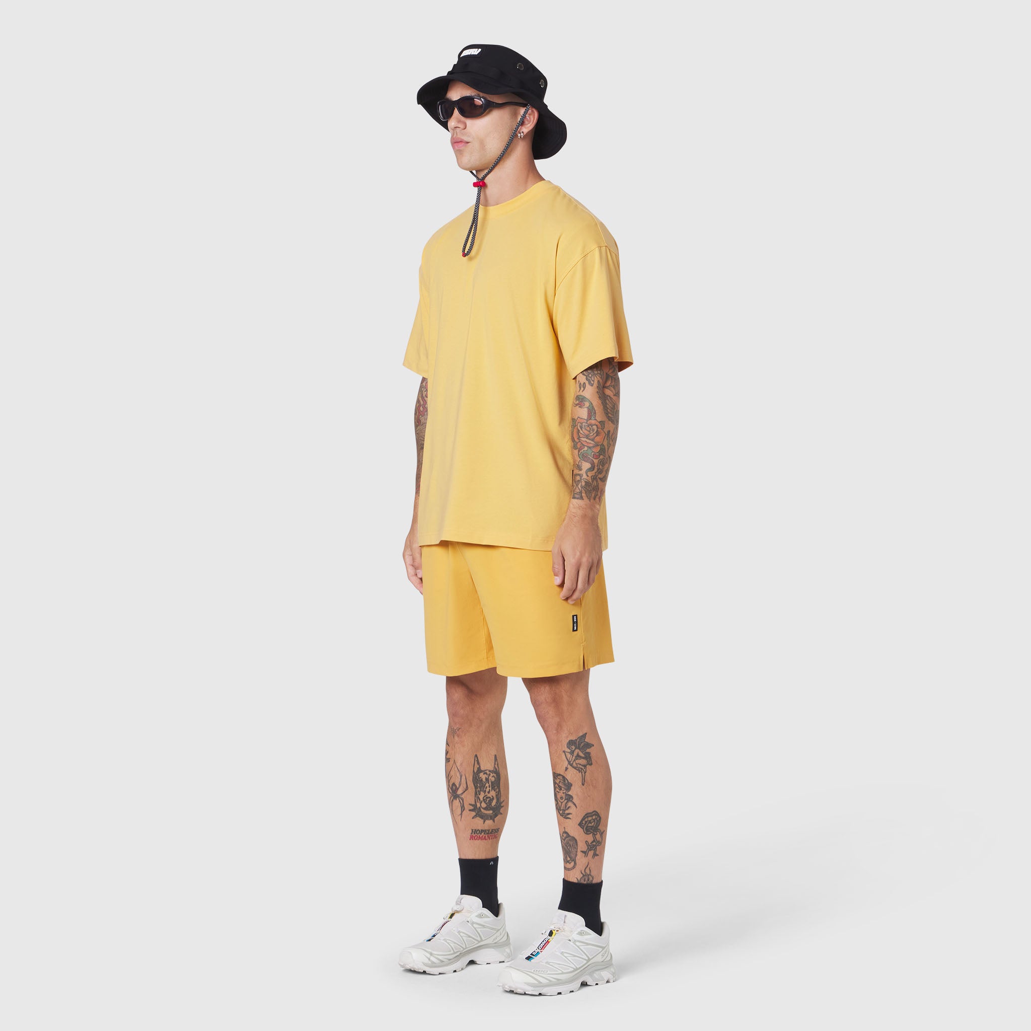Supima Ice-Skin Reversible Tee in amber yellow worn by model, side view