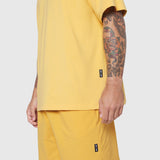 Supima Ice-Skin Reversible Tee in amber yellow worn by model, side view