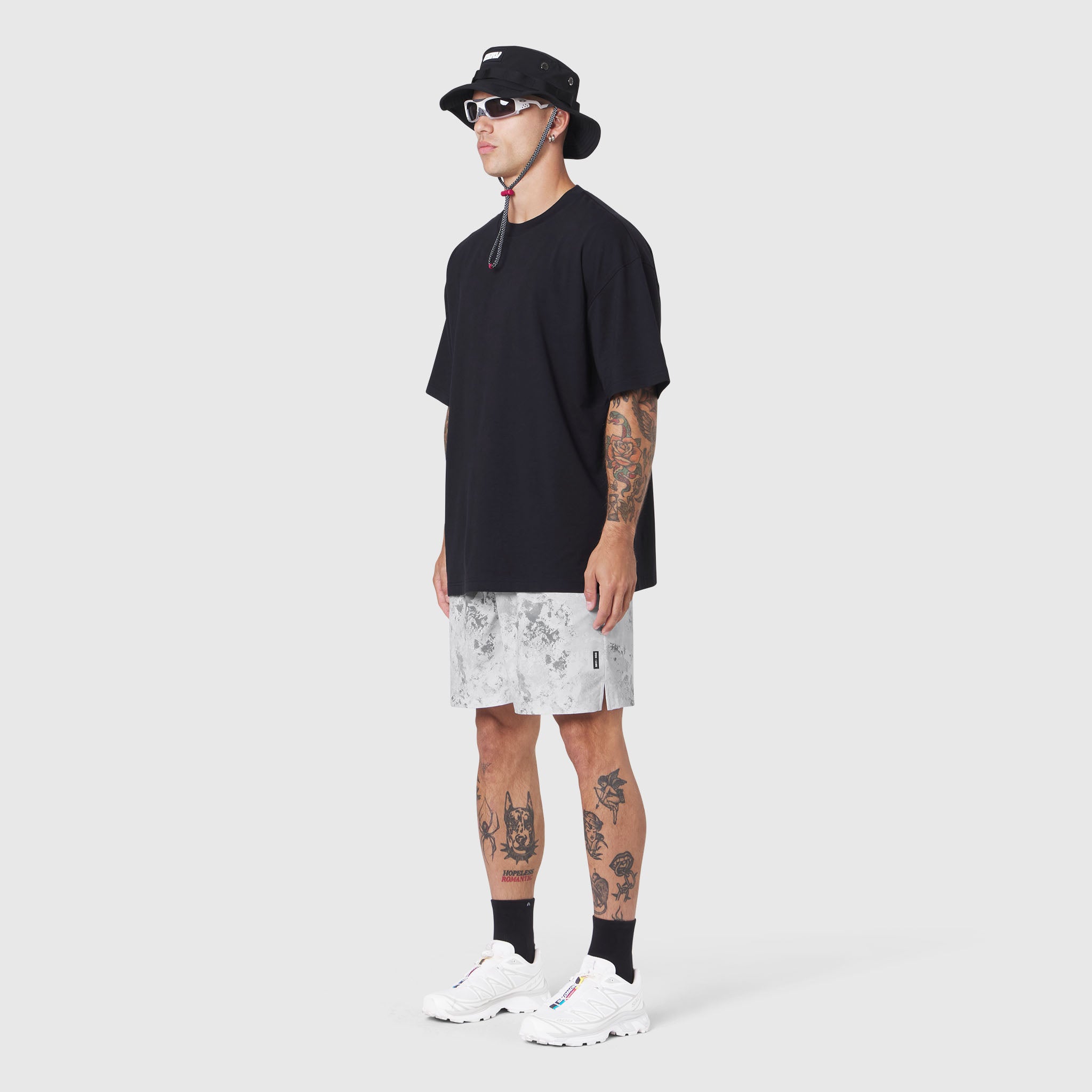 Black Supima Ice-Skin Reversible Tee worn with patterned shorts, side view on model