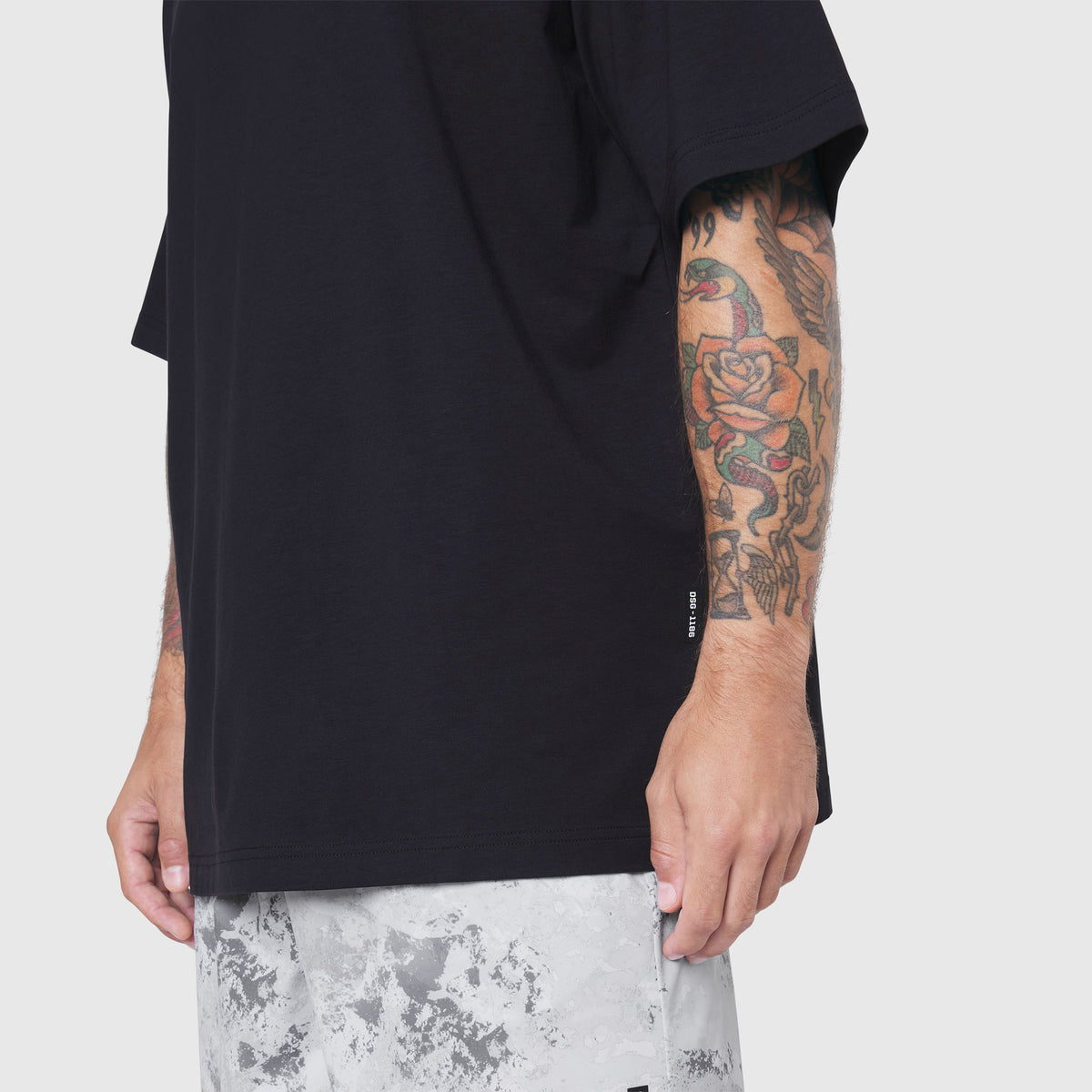 Black Supima Ice-Skin reversible tee on model, side view showing sleeve and fit
