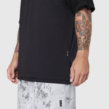 Black Supima Ice-Skin Reversible Tee worn by model showing side view with tattoos visible