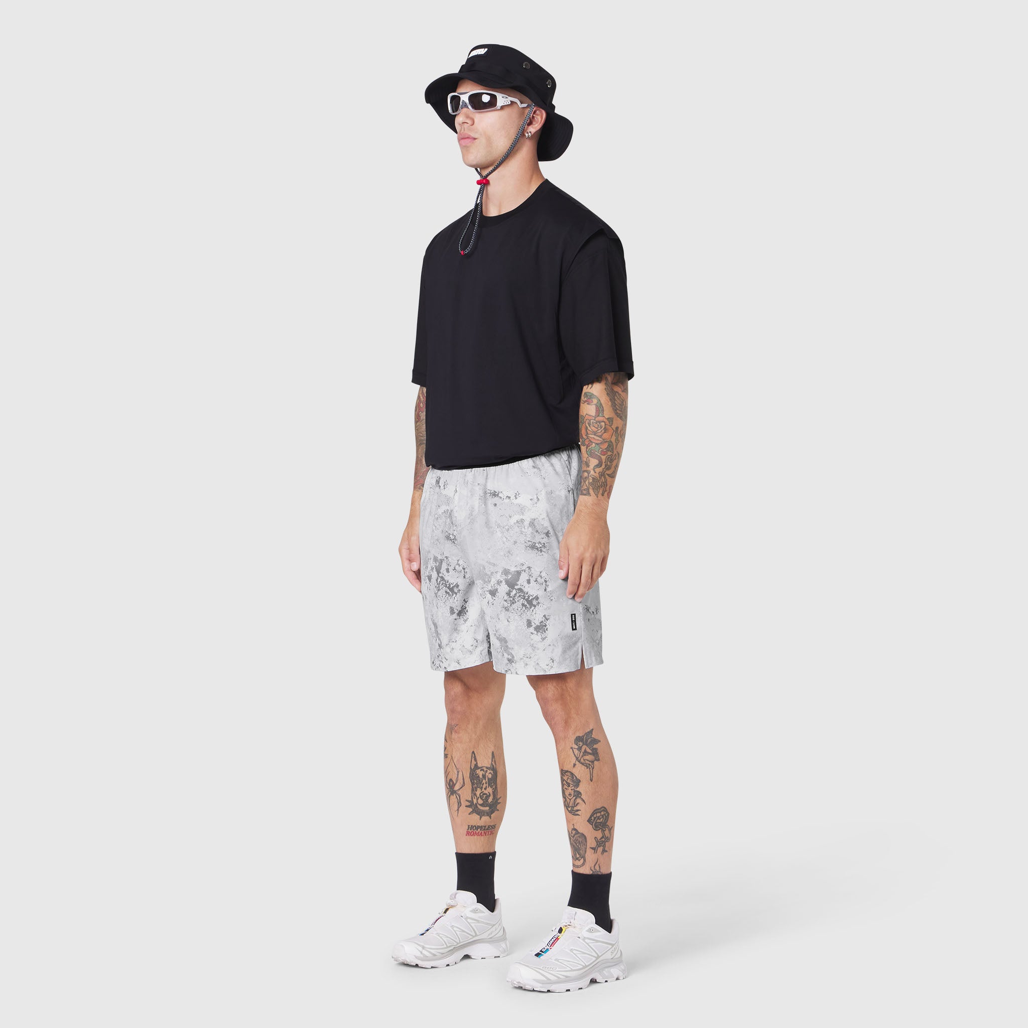 Black Supima Ice-Skin Reversible Tee worn with white patterned shorts, front view on model