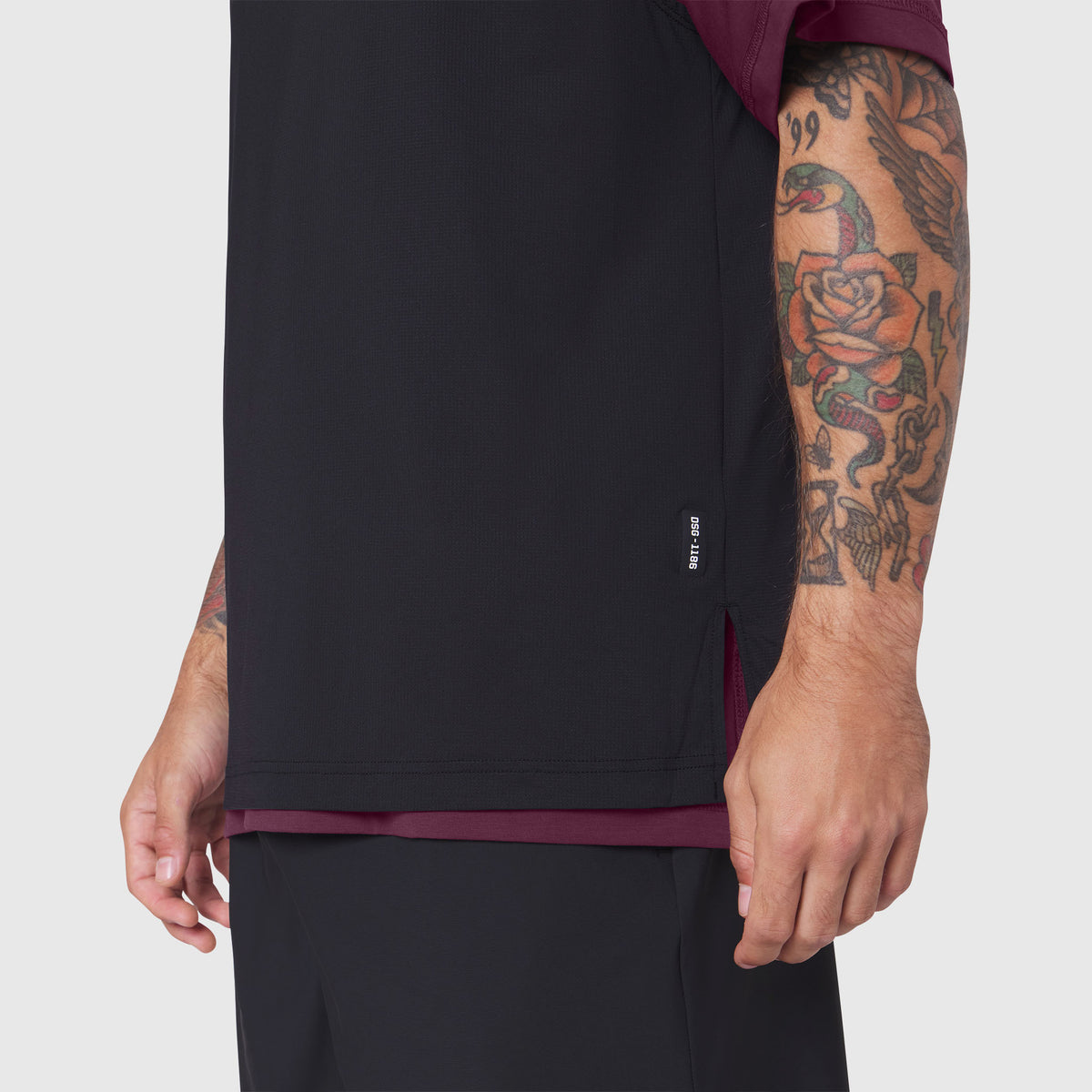 Supima Ice-Skin reversible tee in merlot and black worn by tattooed model, side view