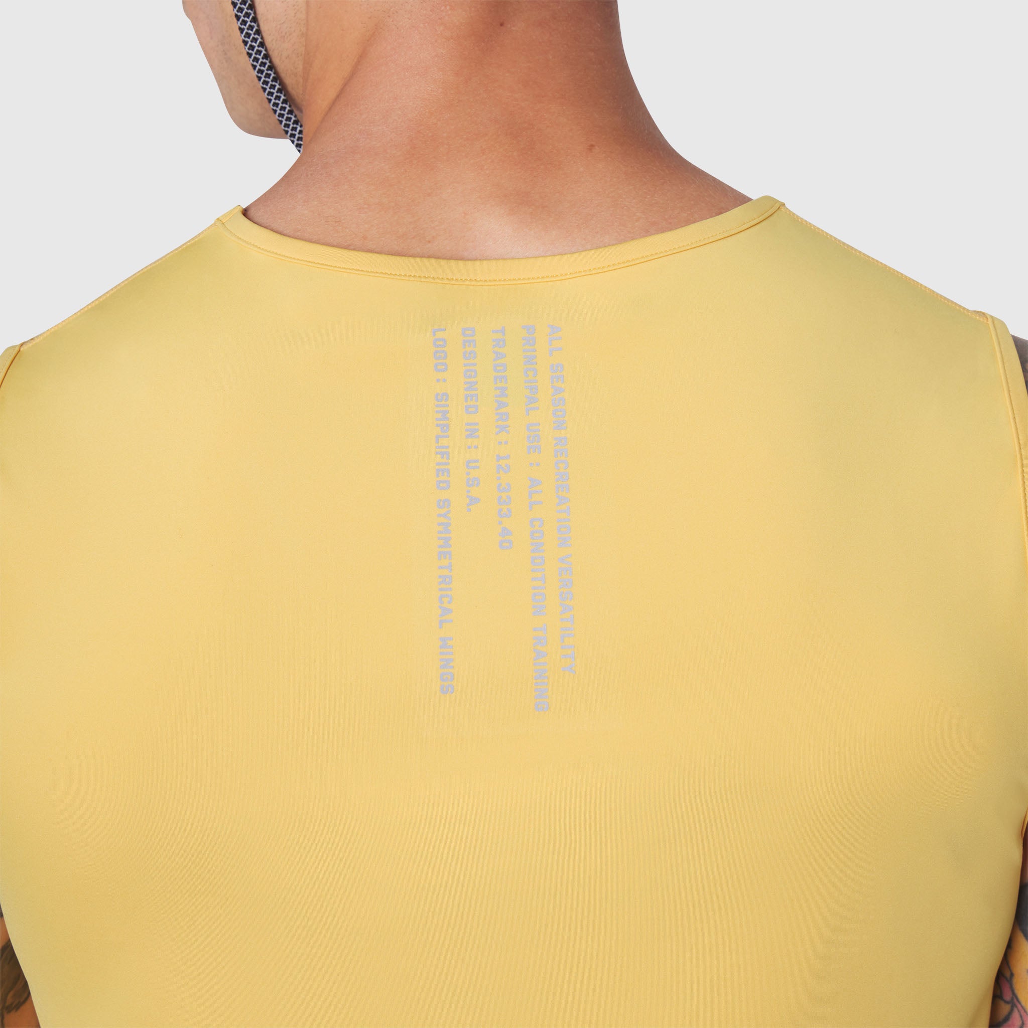 Warpflexx-Lite Training Tank in amber yellow, back view on model