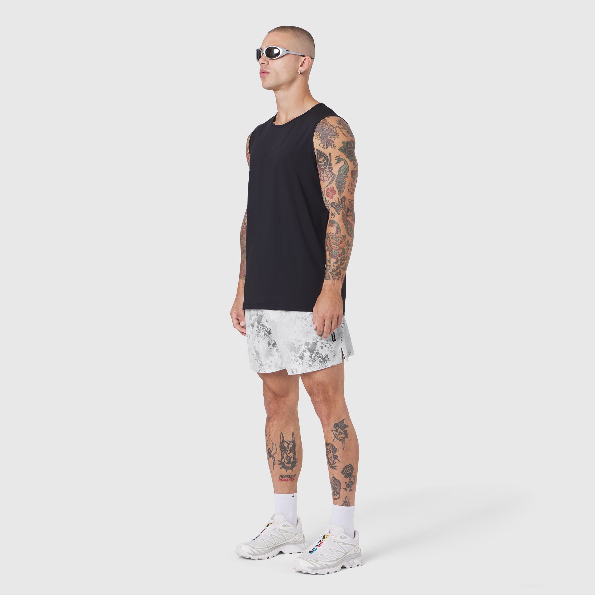 Black Warpflexx-Lite Training Tank worn with white shorts, side view on model