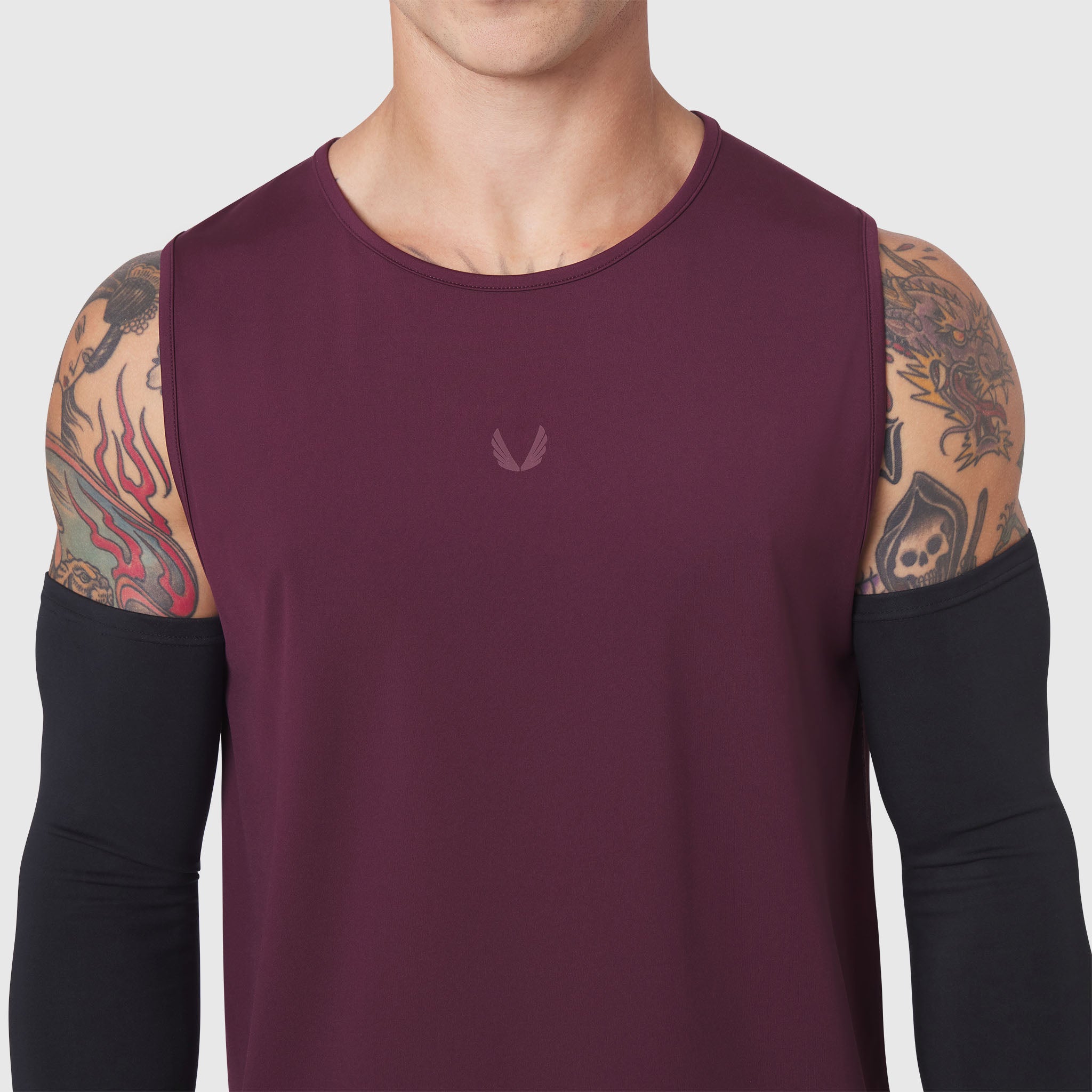 Warpflexx-Lite Training Tank in merlot worn with black arm sleeves, front view