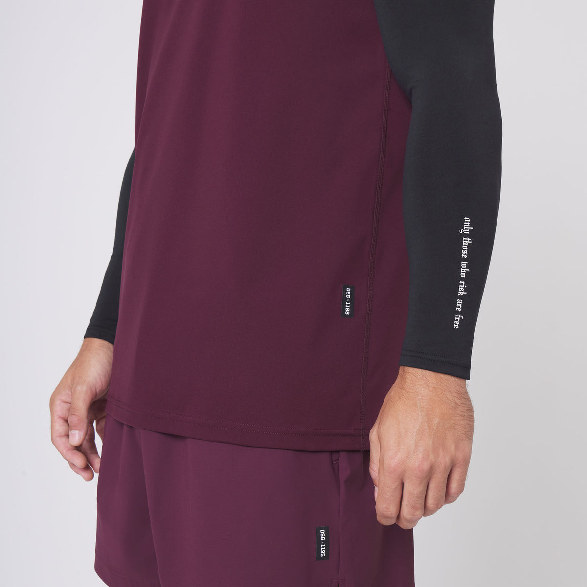 Warpflexx-Lite Training Tank in merlot worn with black long sleeve, side view