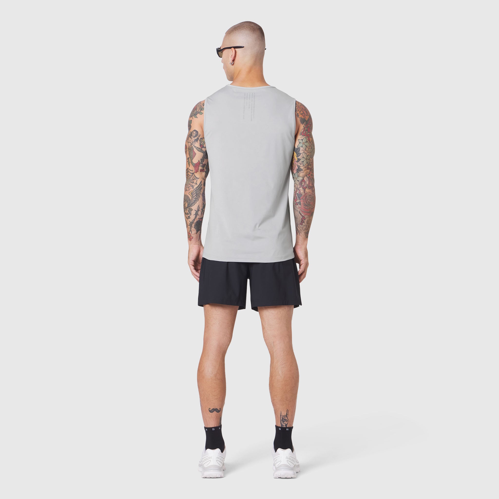 Warpflexx-Lite Training Tank in slate grey, worn by model from back, paired with black shorts