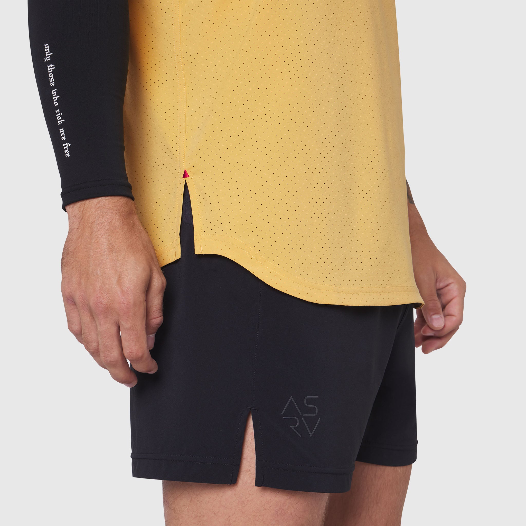 Aerotex Perforated Run Tank in amber worn with black shorts, side view