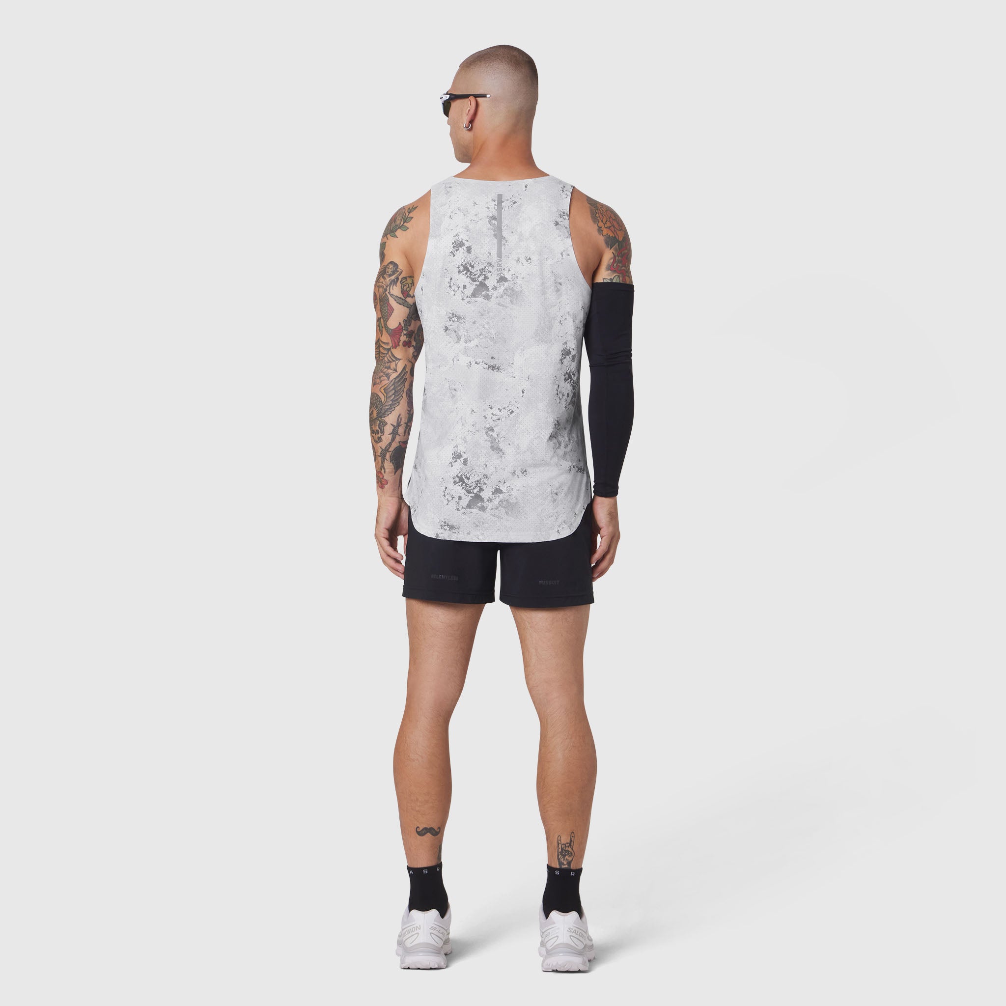 Aerotex Perforated Run Tank in Sedona Snow Camo, worn by model from back, paired with black shorts