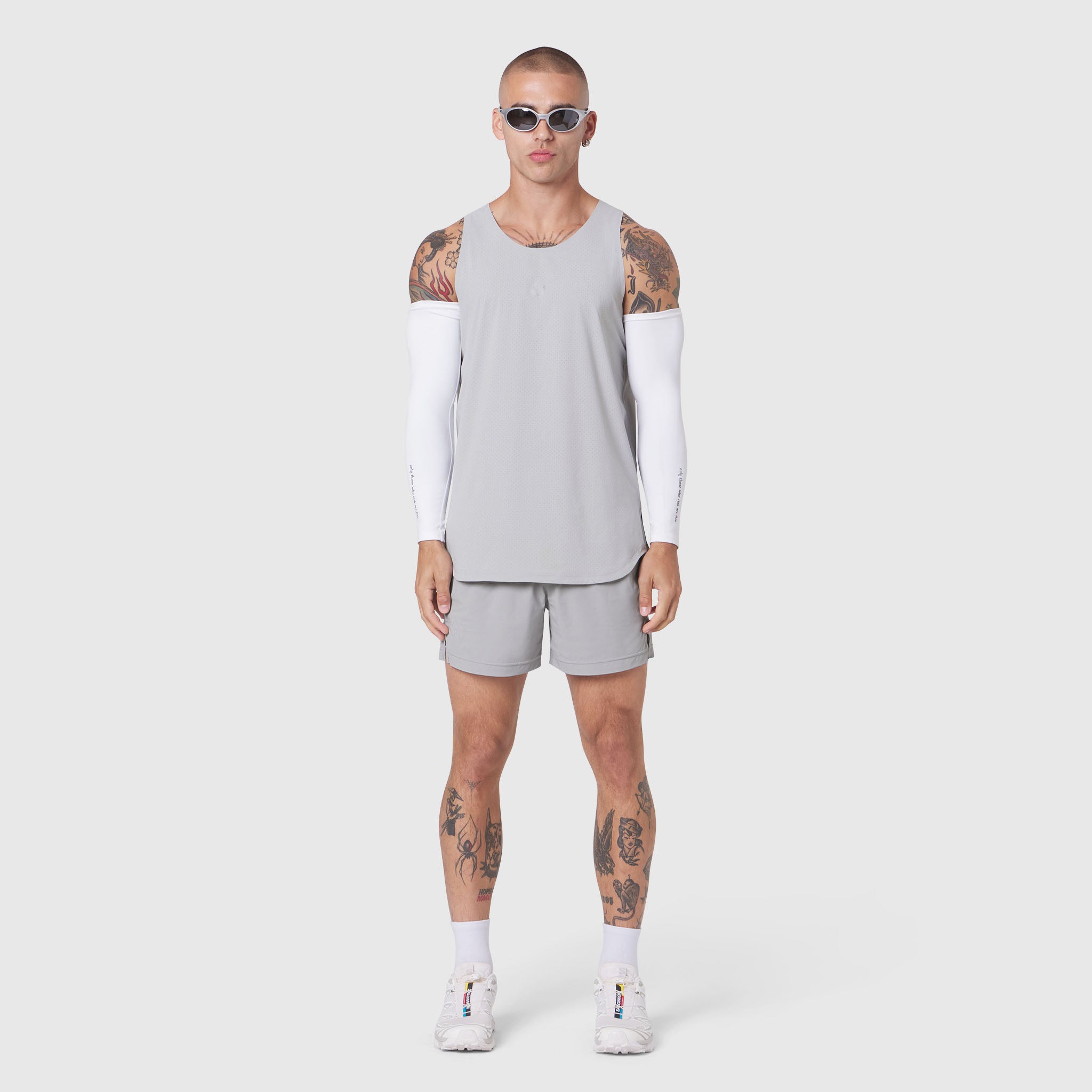 Aerotex Perforated Run Tank in slate grey, worn with matching shorts and white arm sleeves