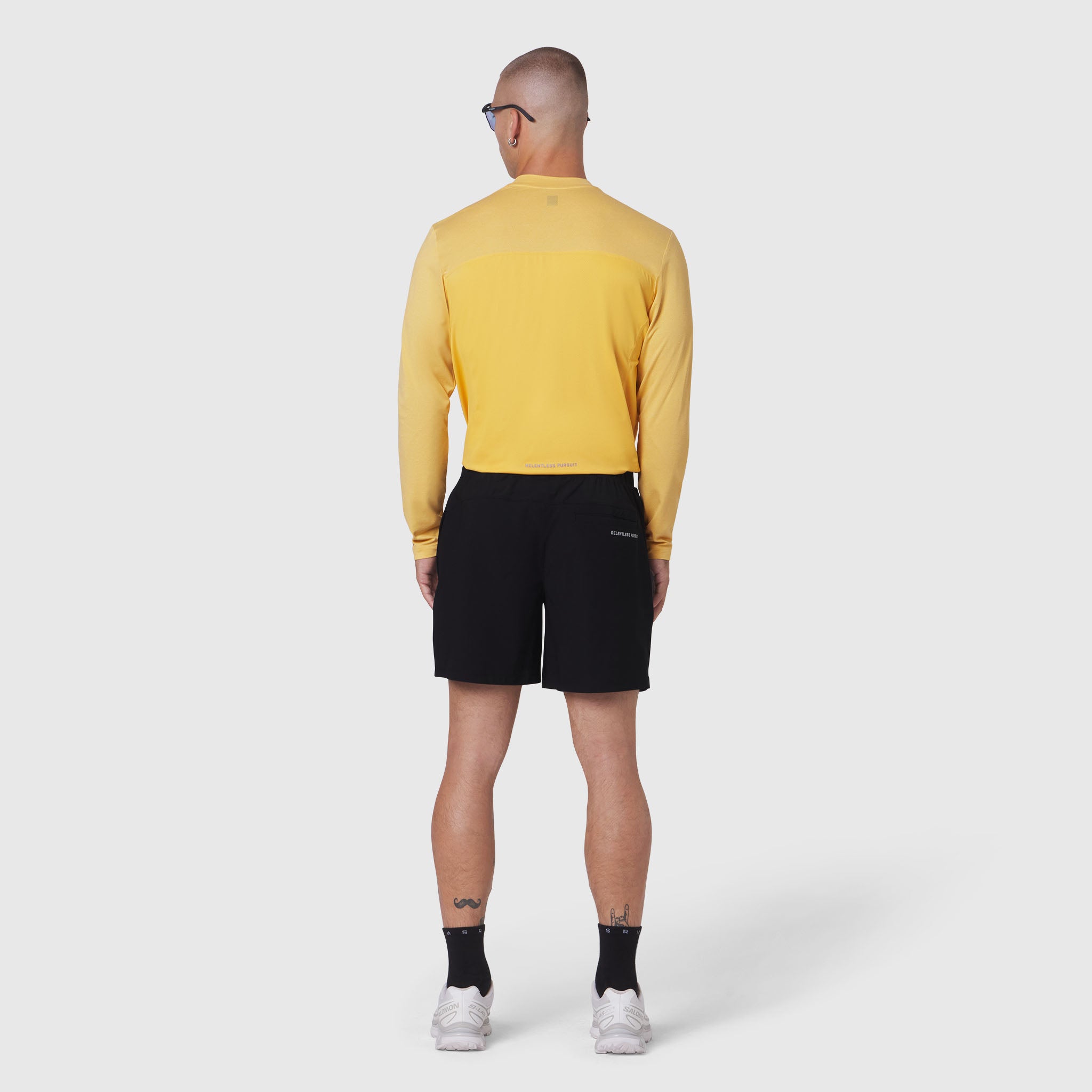 AEROSILVER® UPF50+ Run Long Sleeve in amber worn with black shorts, back view