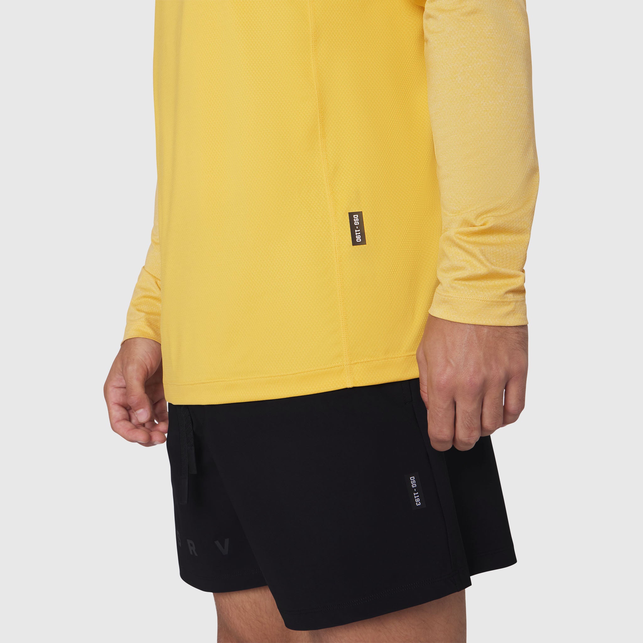 AEROSILVER® UPF50+ Run Long Sleeve in amber yellow worn with black shorts, side view