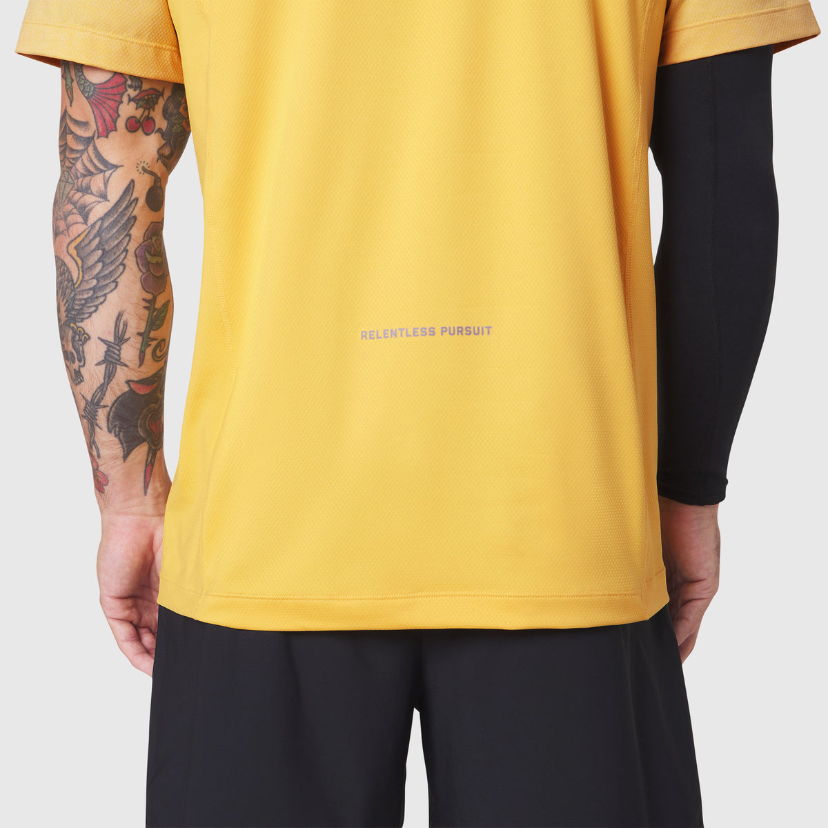 AEROSILVER® UPF50+ Run Tee in amber yellow worn by model, back view