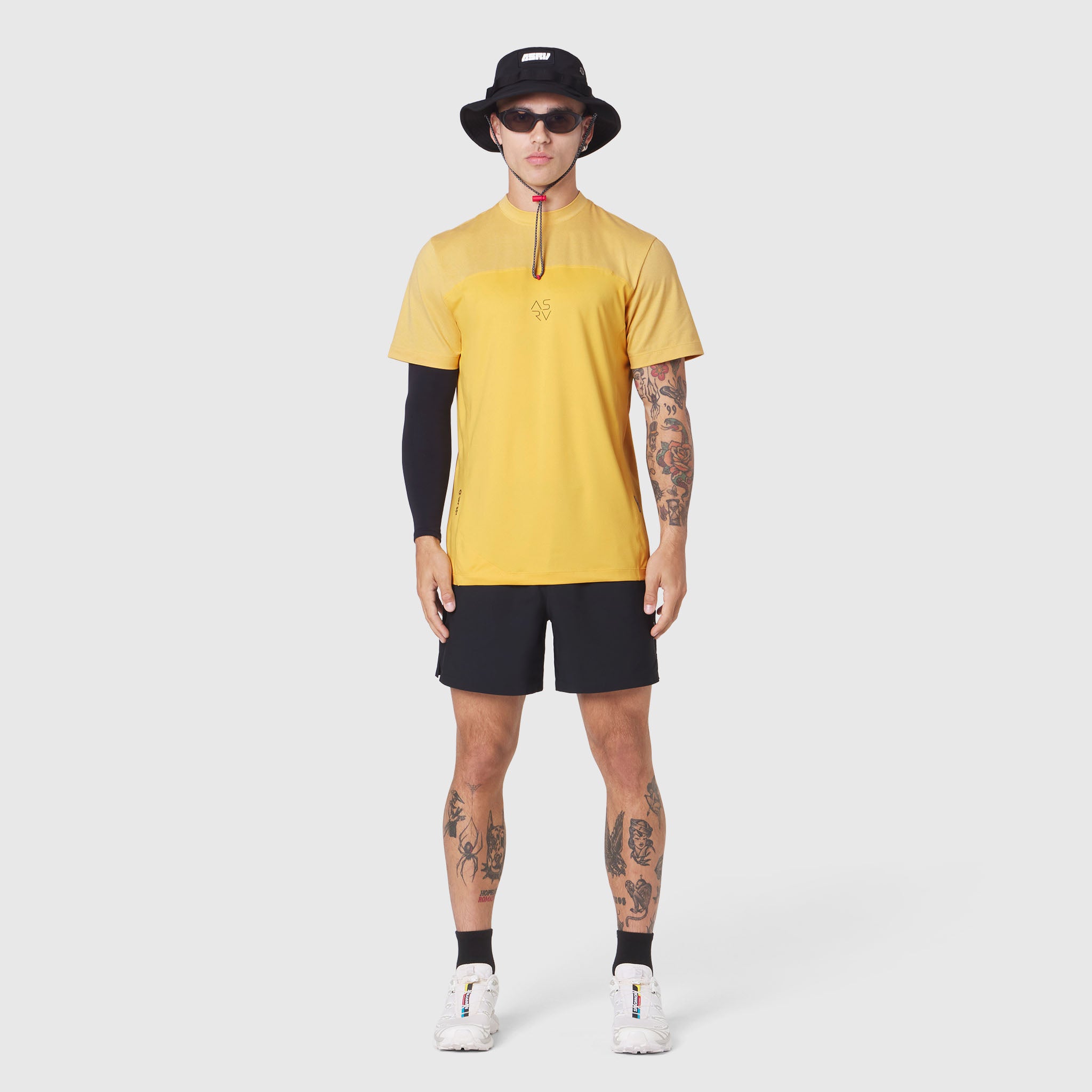 AEROSILVER® UPF50+ Run Tee in amber yellow worn by model with black shorts, front view