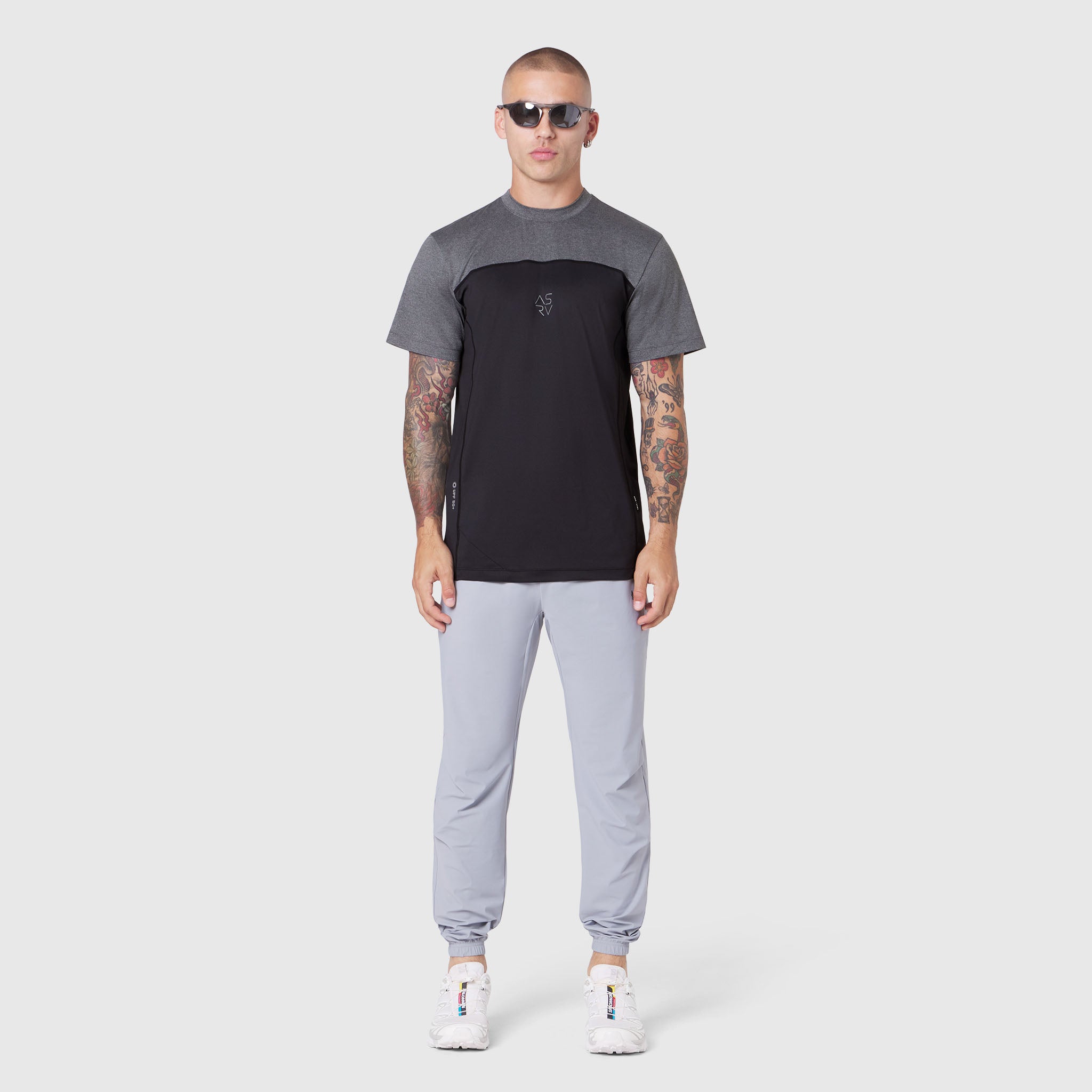 AEROSILVER® UPF50+ Run Tee in black and grey colorblock, worn by model with light grey joggers