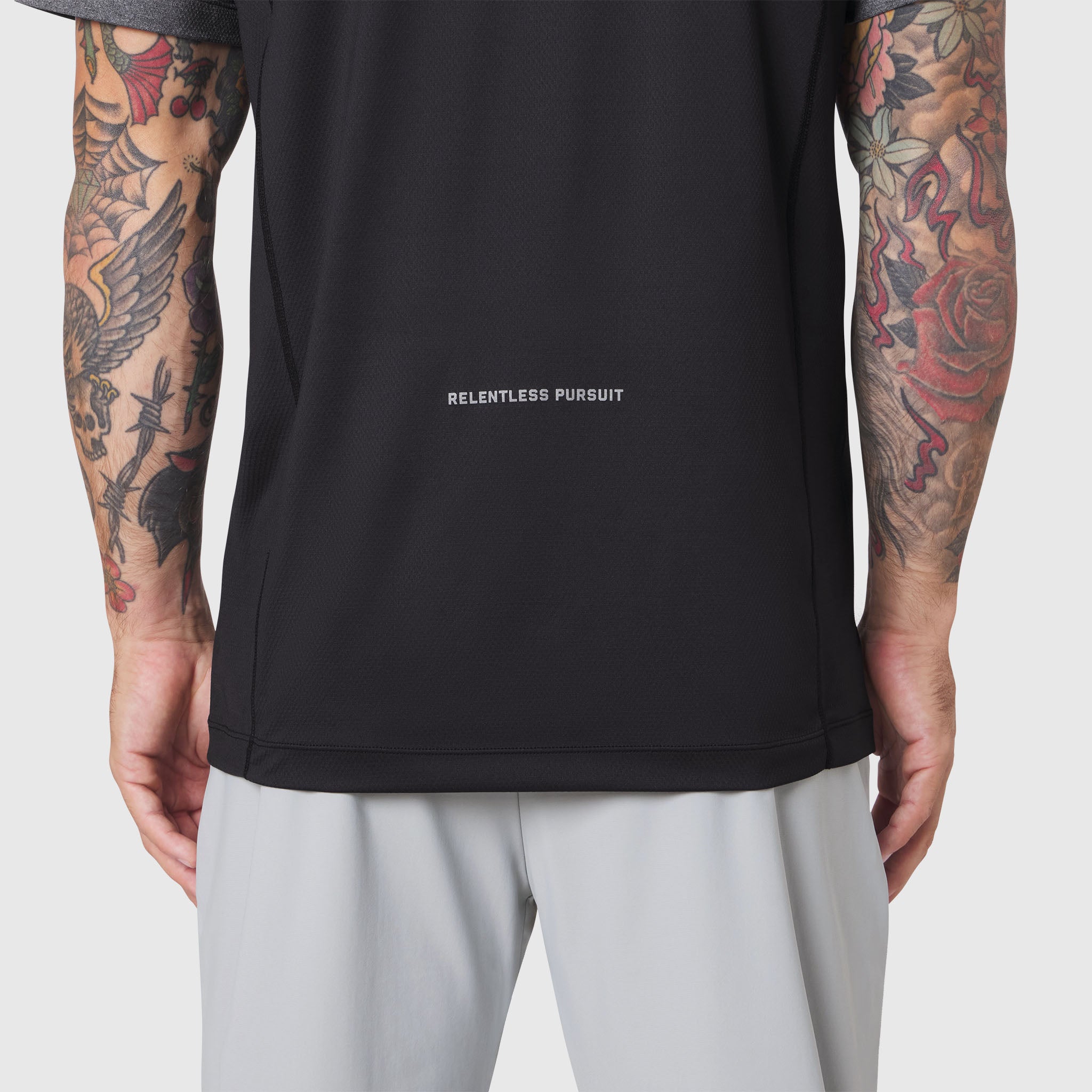 AEROSILVER® UPF50+ Run Tee in black, worn by tattooed model, back view