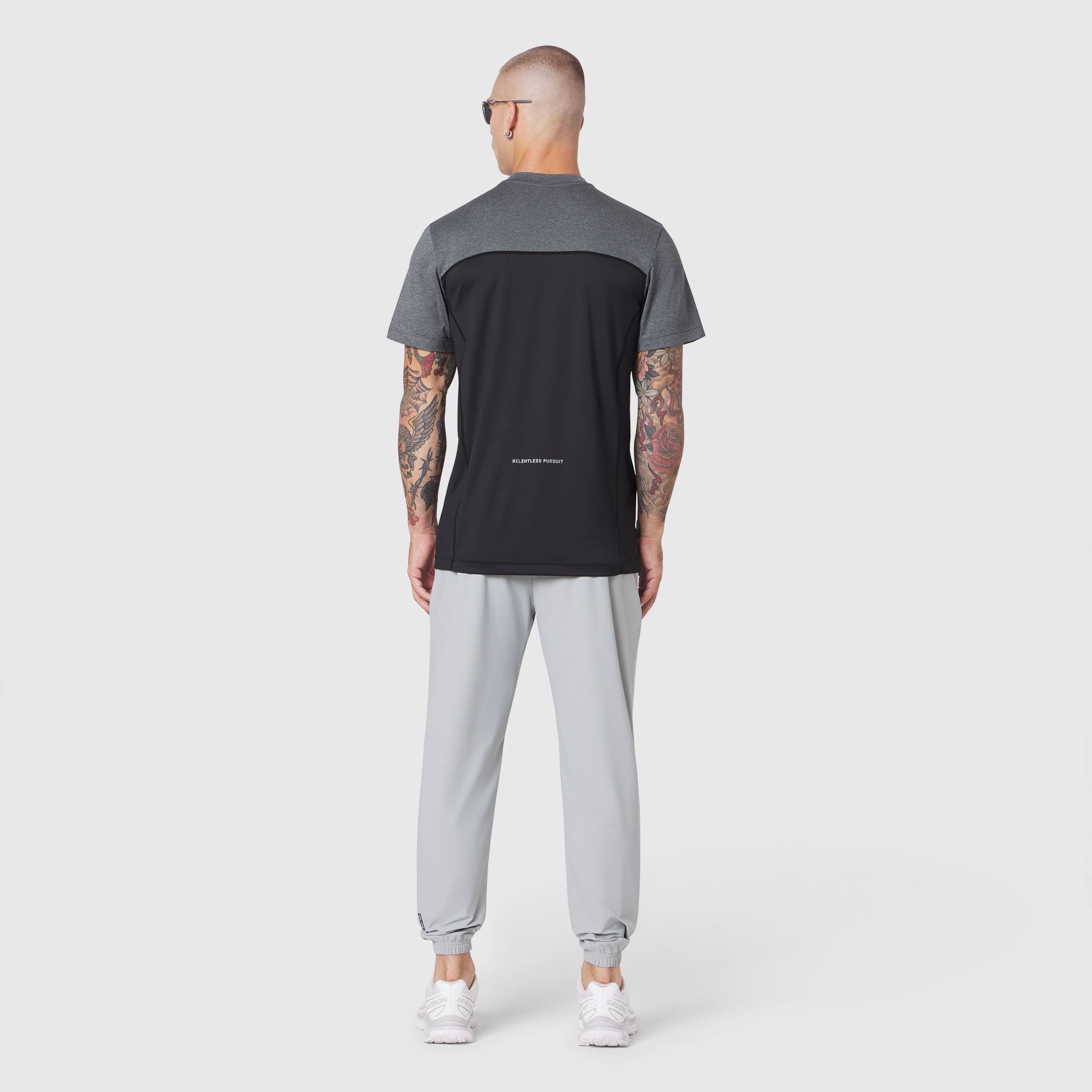 AEROSILVER UPF50+ Run Tee in black and gray colorblock, back view on model