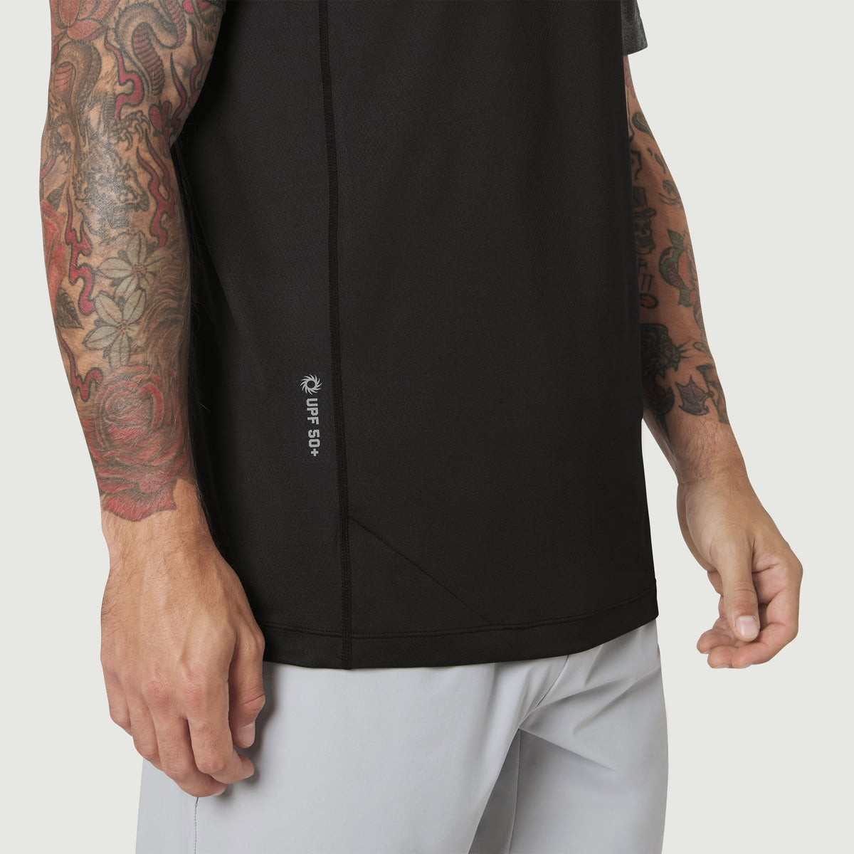 Black AEROSILVER® UPF50+ Run Tee worn by tattooed model, side view