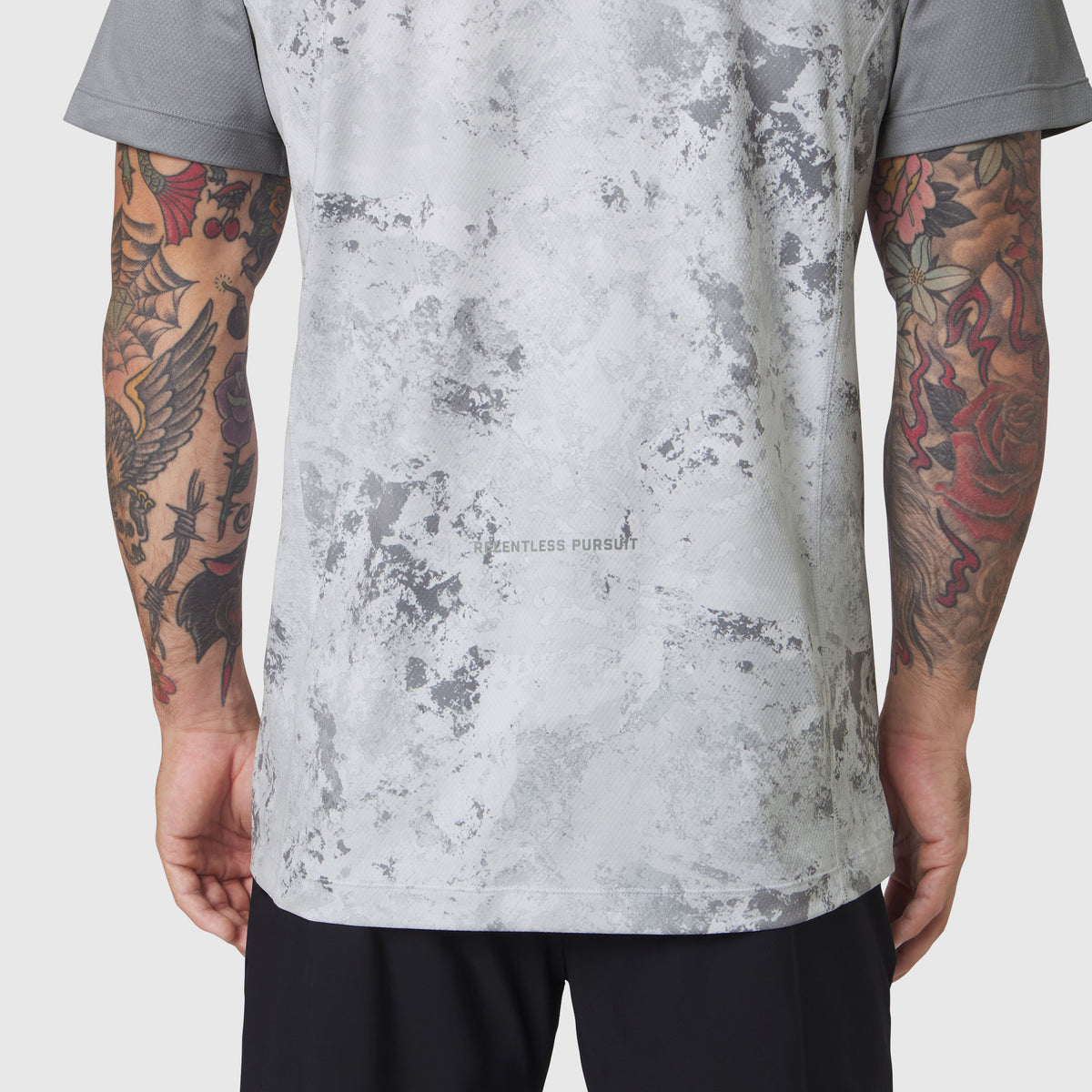 AEROSILVER® UPF50+ Run Tee in Sedona Snow Camo worn by model showing back view with tattooed arms