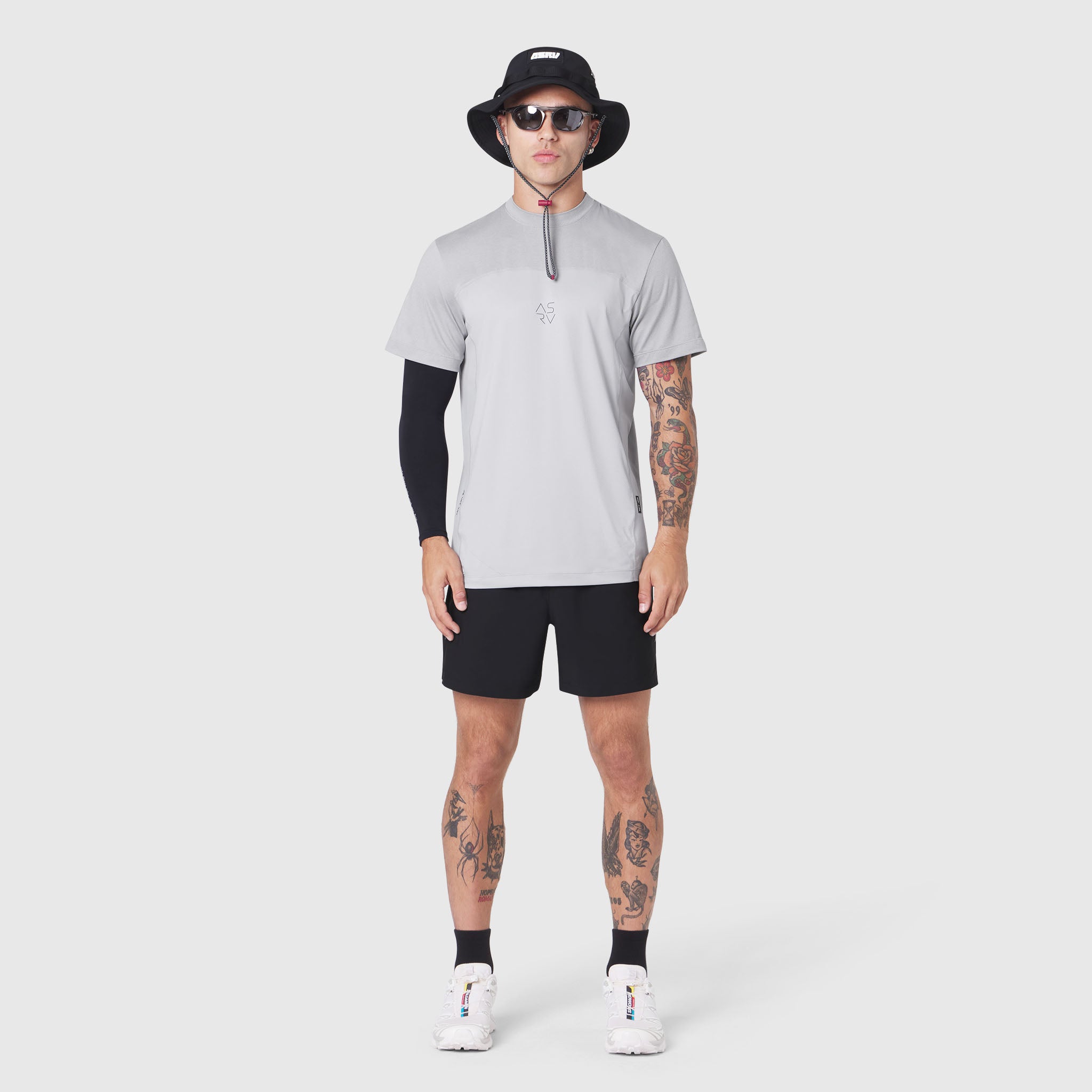 AEROSILVER® UPF50+ Run Tee in slate grey, worn with black shorts and arm sleeve, front view