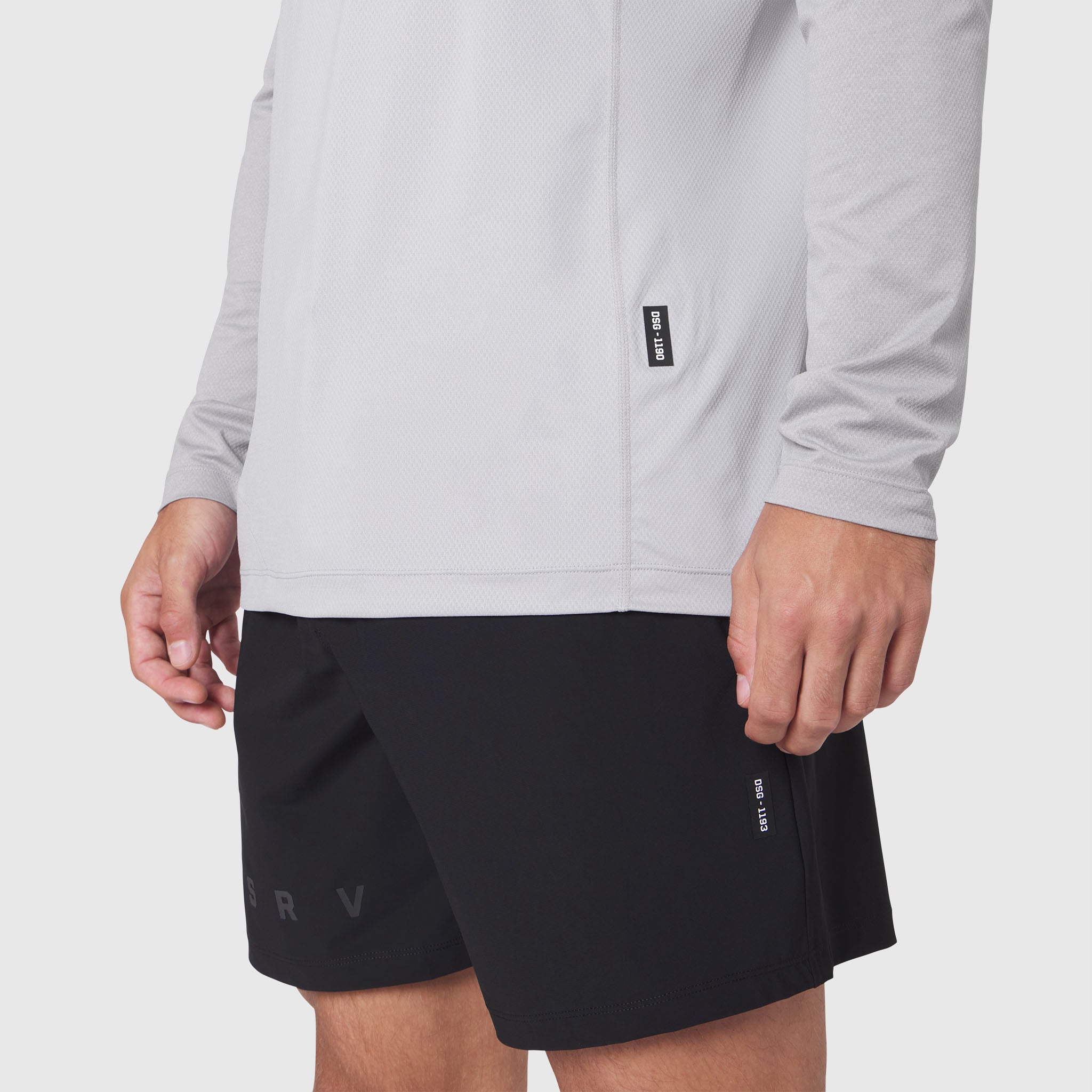 Revolutional Training Short in black worn with white long-sleeve top, front view