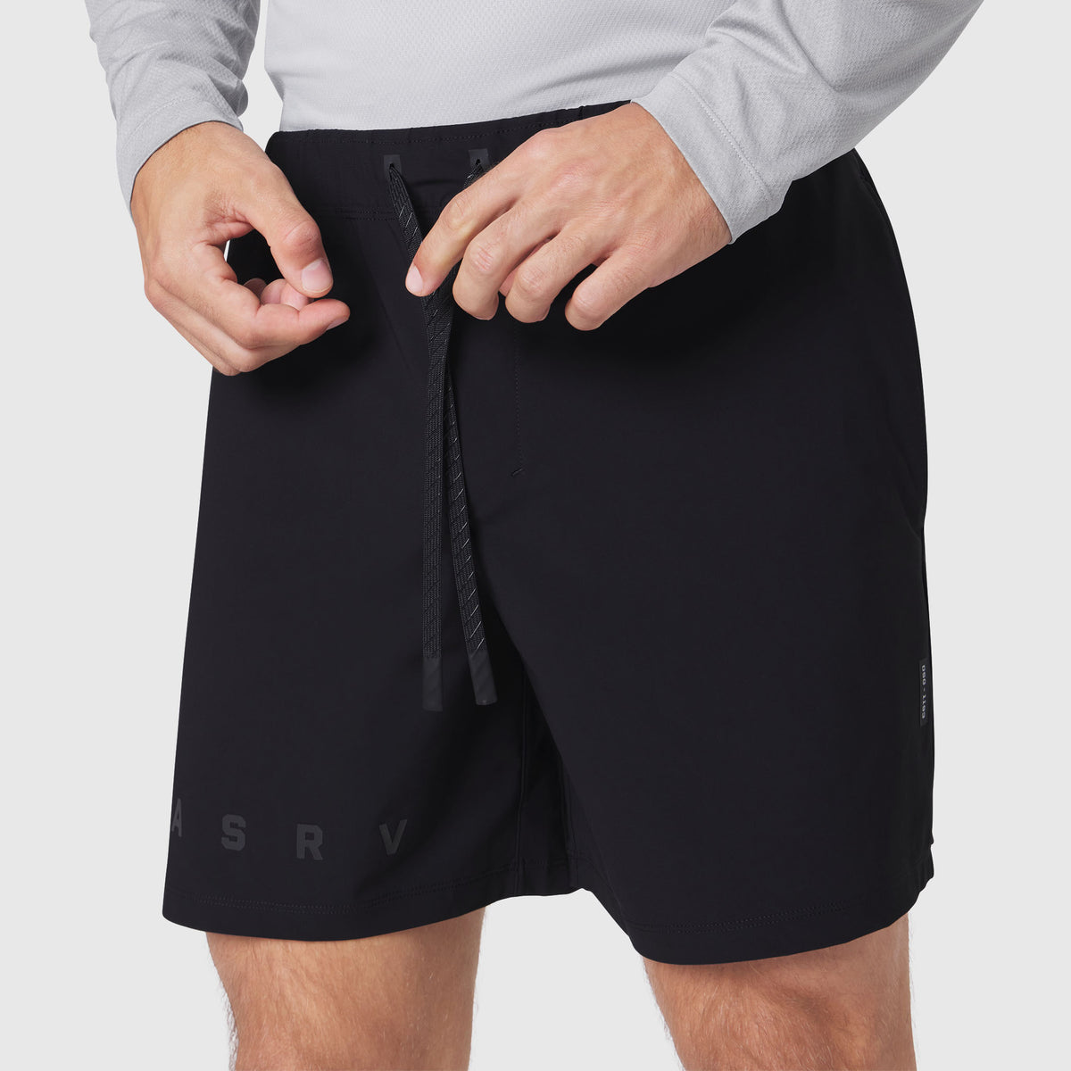 Black Revolutional Training Short worn by model, front view with drawstring detail