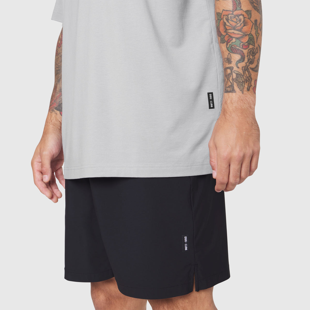 Model wearing light grey t-shirt and black Revolutional Training Shorts, front view
