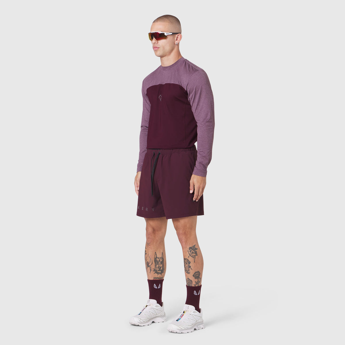 Revolutional Training Short in merlot, worn with matching long-sleeve top and socks, side view