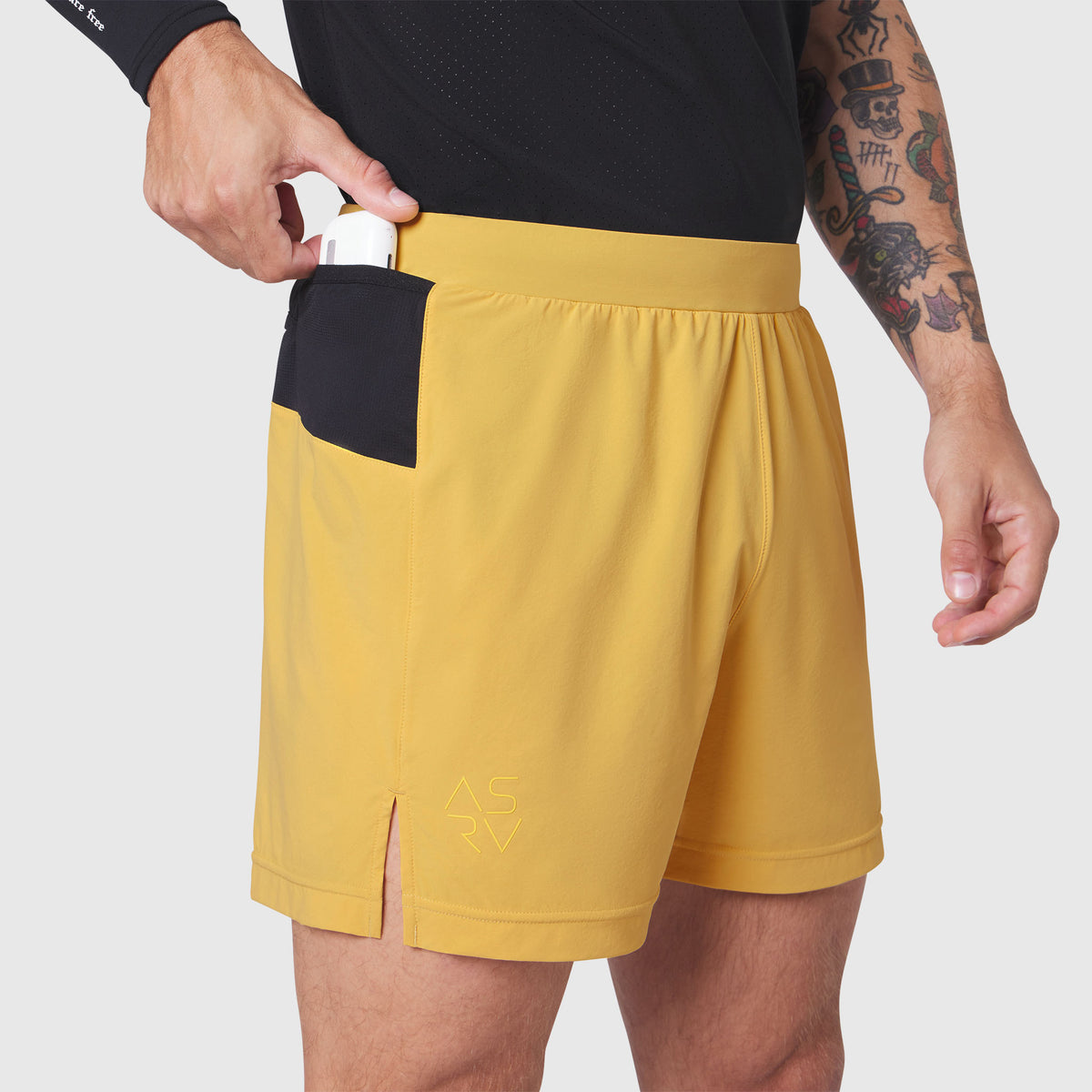 Aerotex™ Distance Run Short in amber yellow worn by model, side view showing pocket detail