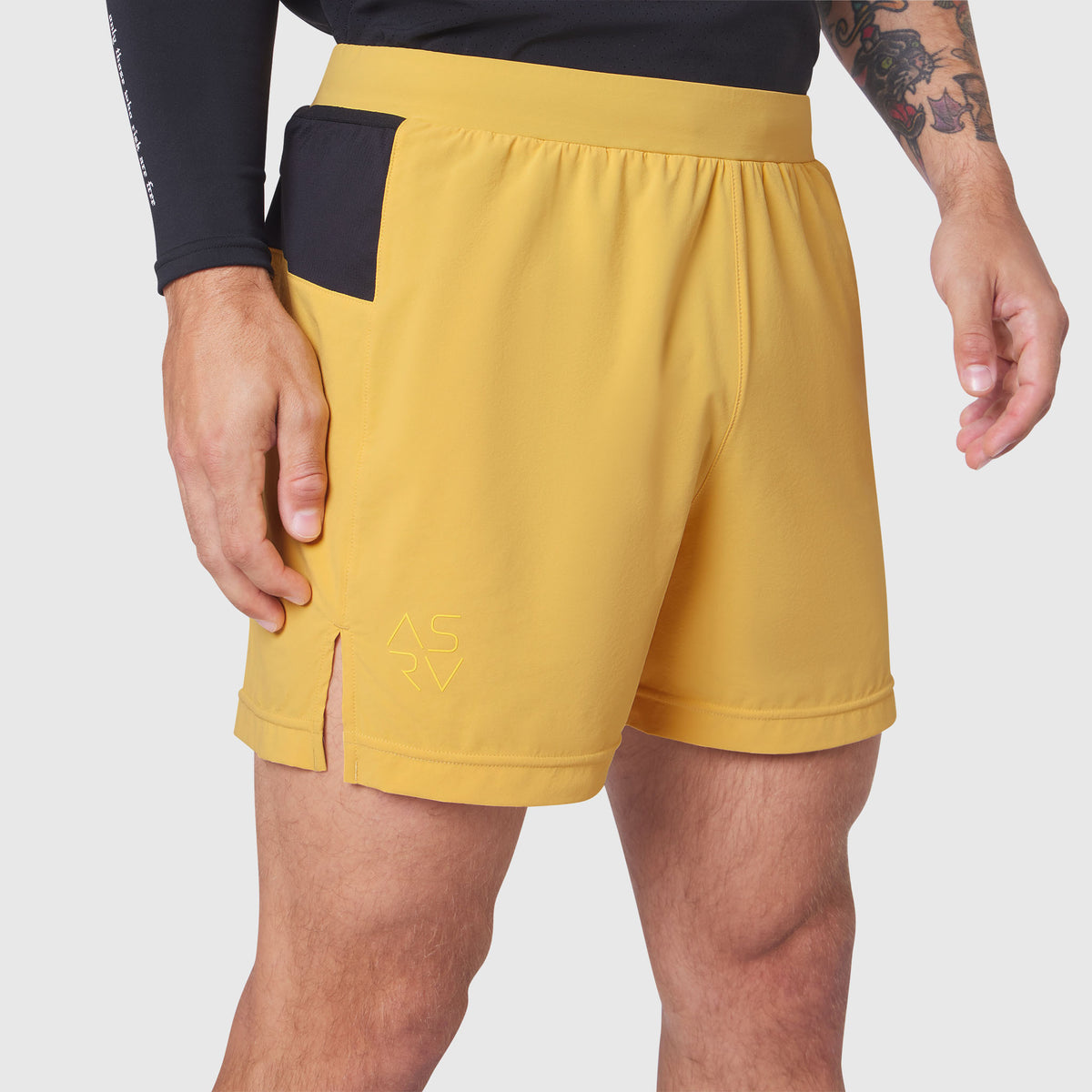 Aerotex Distance Run Short in amber yellow worn by model, side view