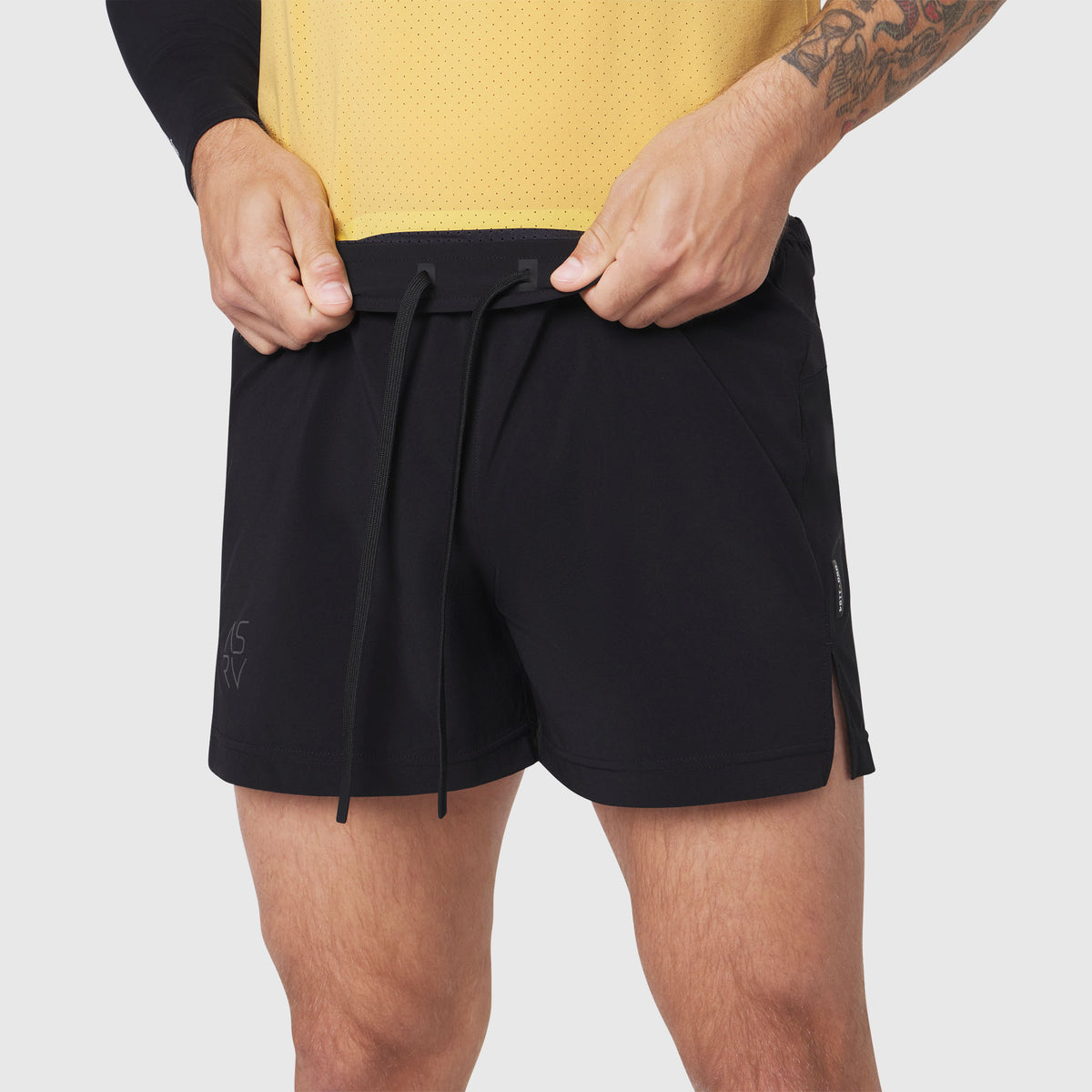 Aerotex™ Distance Run Short in black, worn by model adjusting waistband