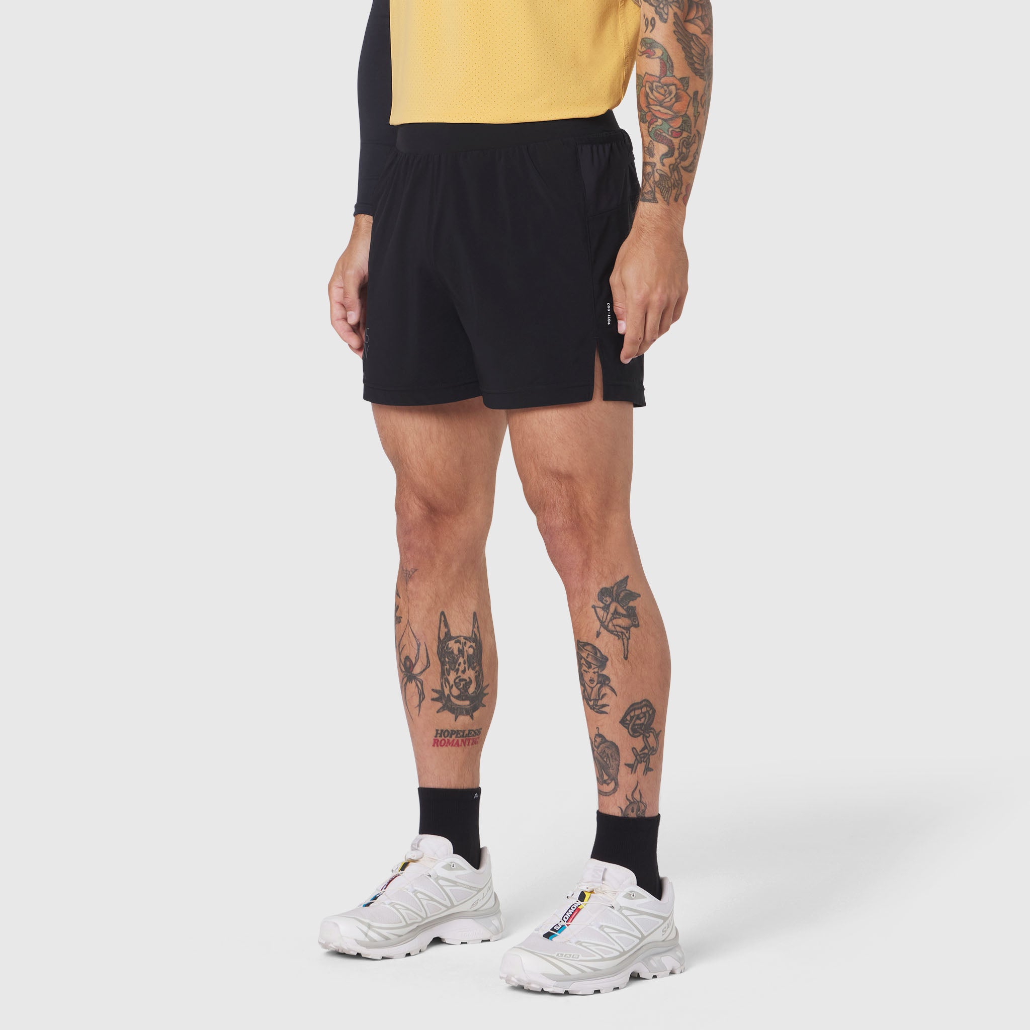 Aerotex Distance Run Short in black, worn with yellow shirt and white sneakers