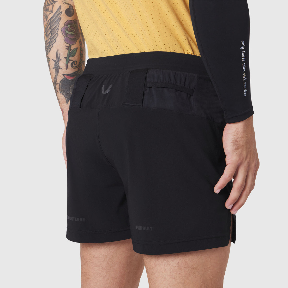 Aerotex Distance Run Short in black, worn by model showing back pocket detail and fit