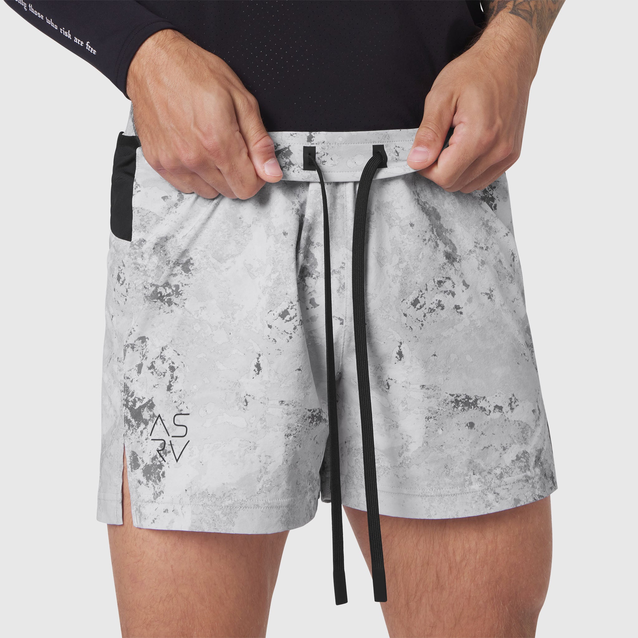 Aerotex Distance Run Short in Sedona Snow Camo worn by model, front view with hands adjusting waistband