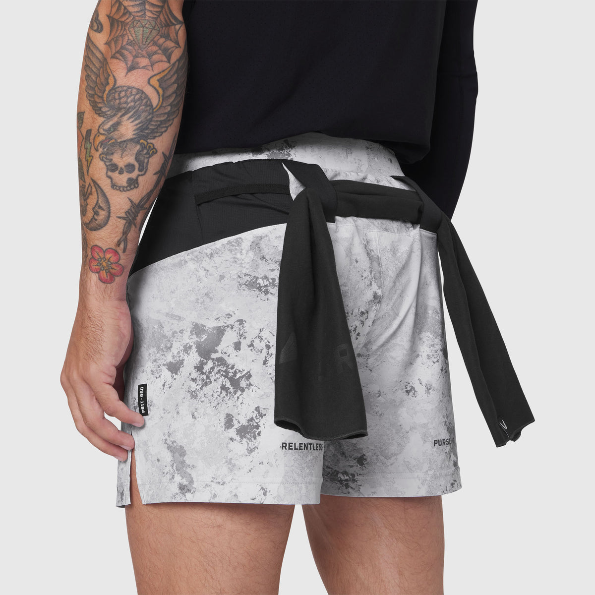 Aerotex Distance Run Short in Sedona Snow Camo worn by model with tattooed arm, side view