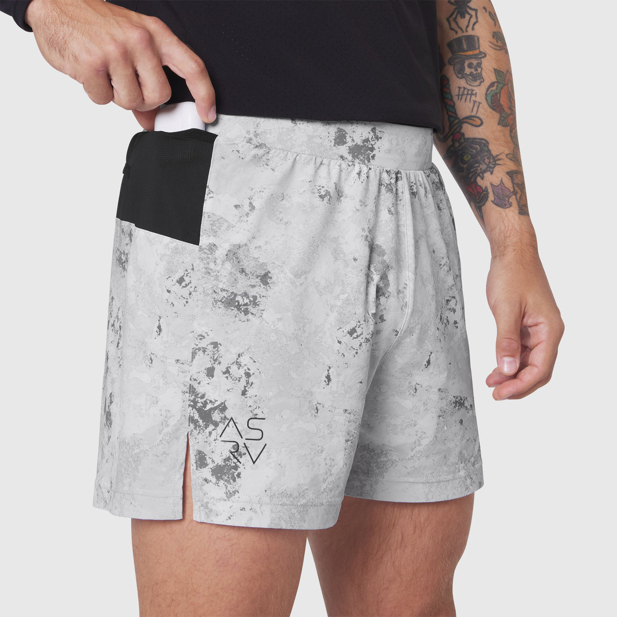Aerotex Distance Run Short in Sedona Snow Camo worn by model, front view with hand in pocket