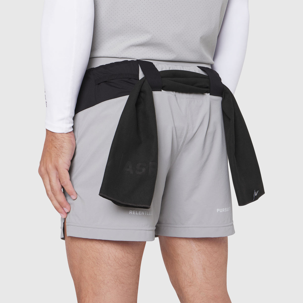 Aerotex Distance Run Short in slate grey worn by model, rear view with black towel