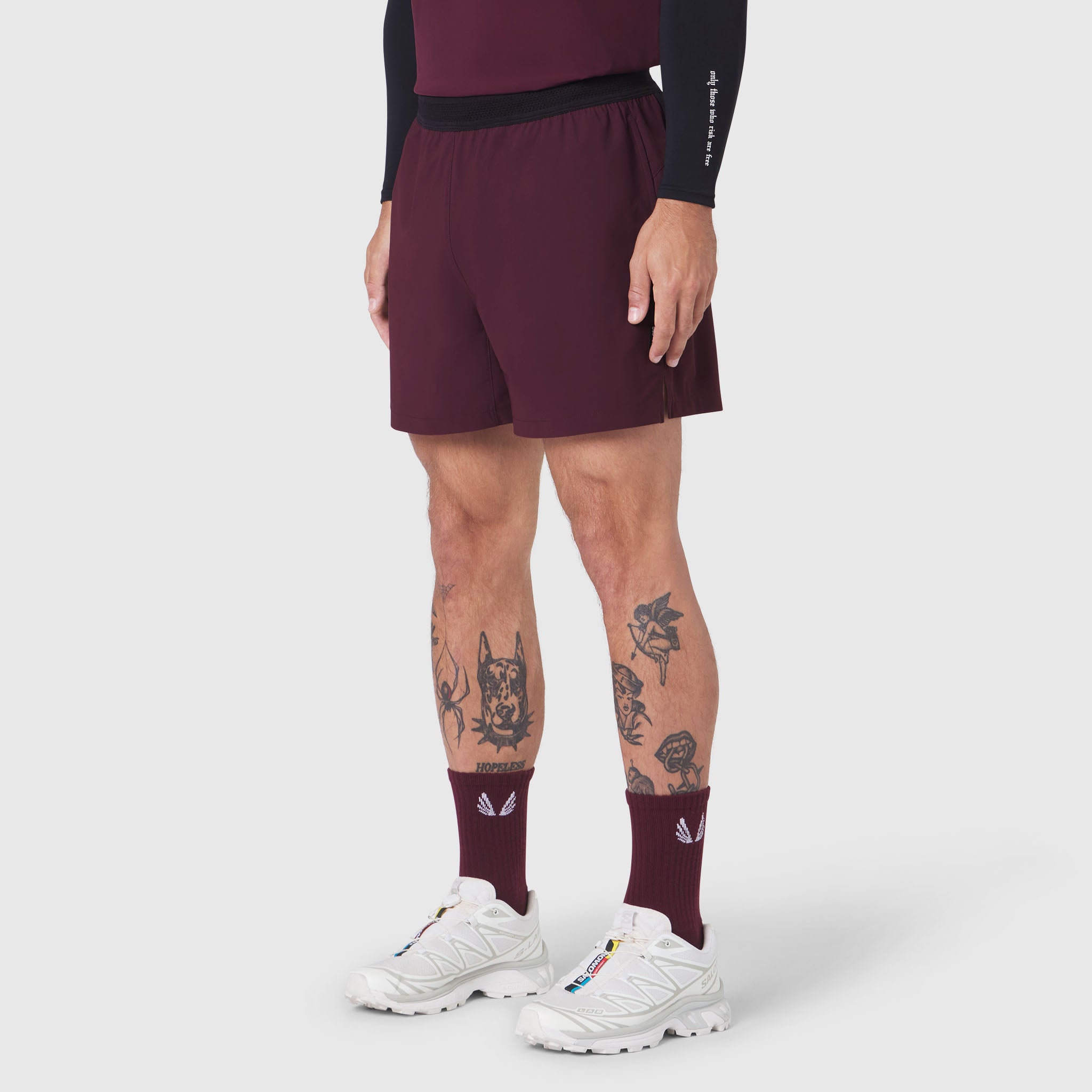 Tetra-Lite 5" Linerless Training Short in merlot, worn with maroon socks and white sneakers