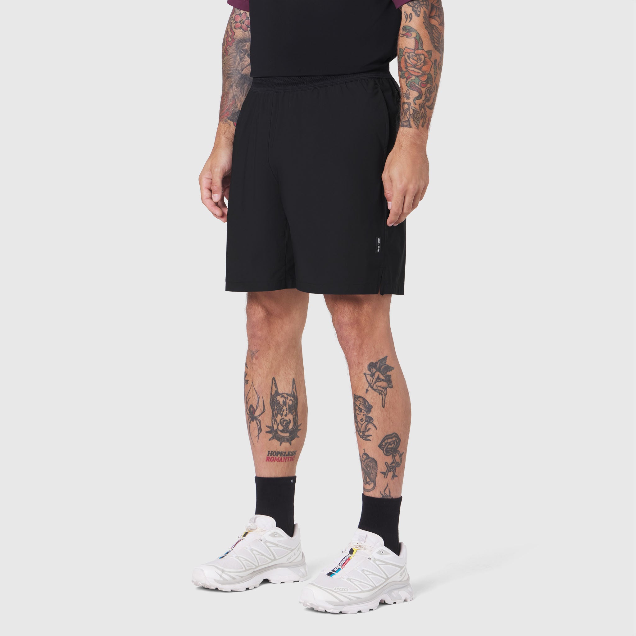 TETRA-LITE® 7" Linerless Training Short in black, worn by model with white sneakers
