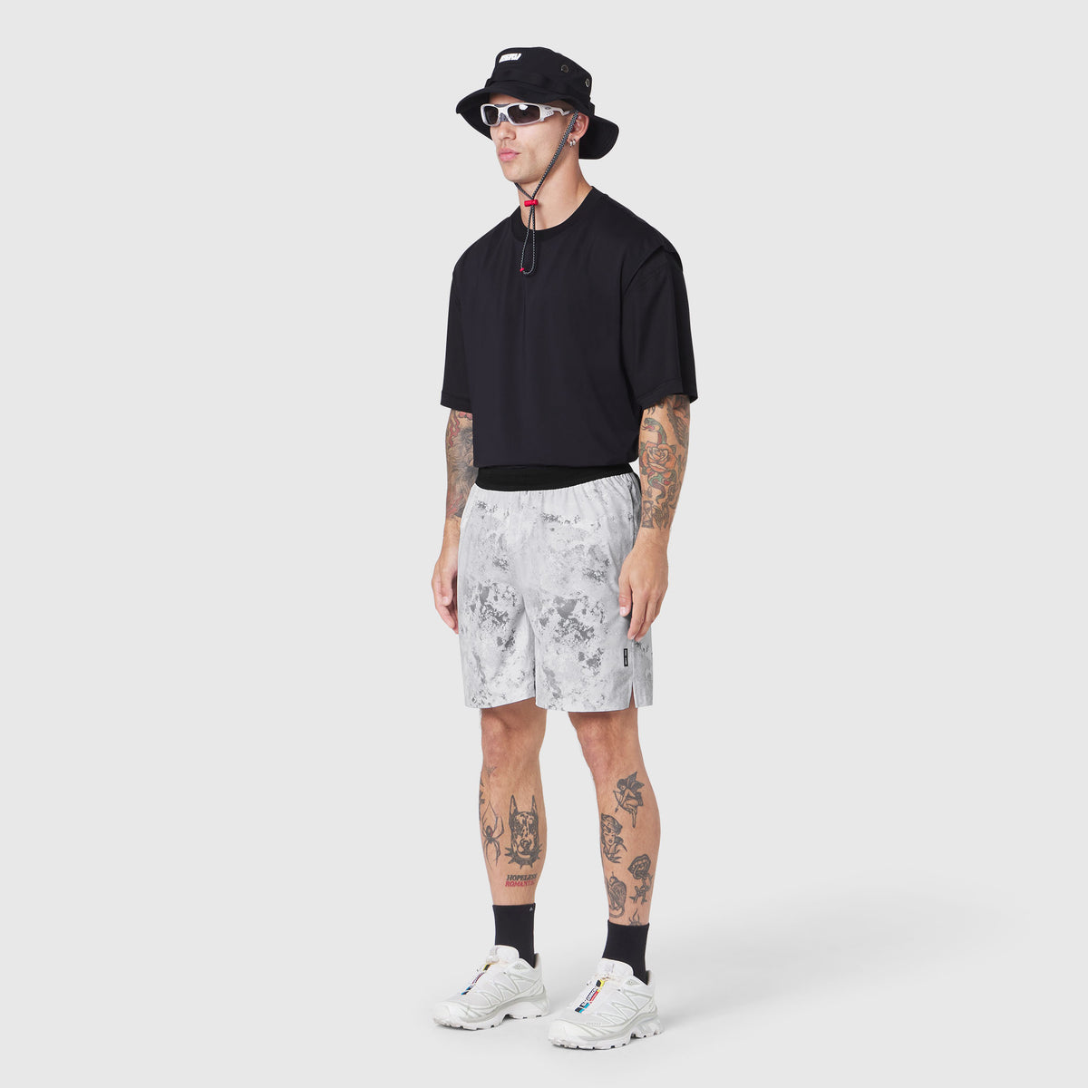 TETRA-LITE 7" Linerless Training Short in Sedona Snow Camo, worn with black tee and white sneakers