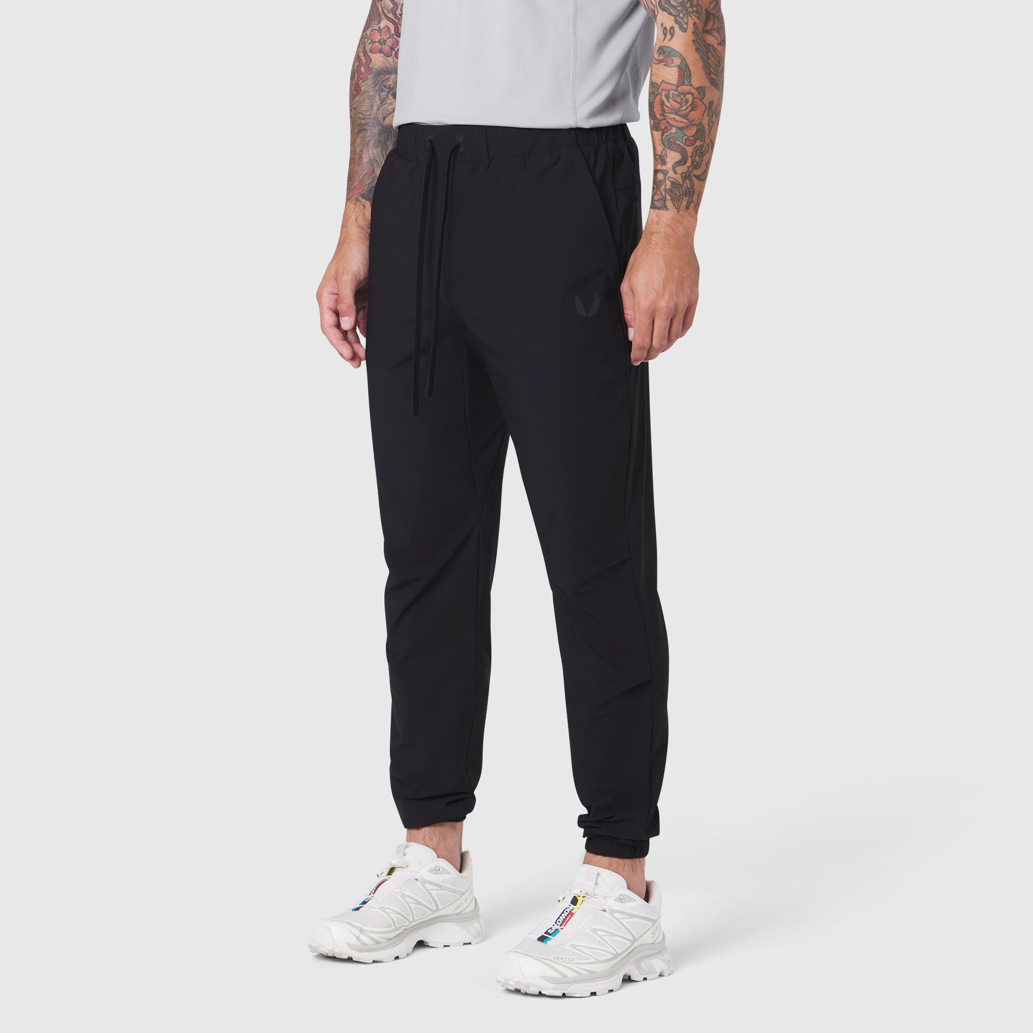 Black TETRA-LITE Training Jogger worn by model with white sneakers, side view