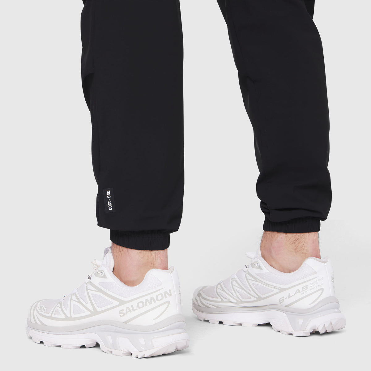 Black TETRA-LITE Training Jogger worn with white sneakers, cropped leg view