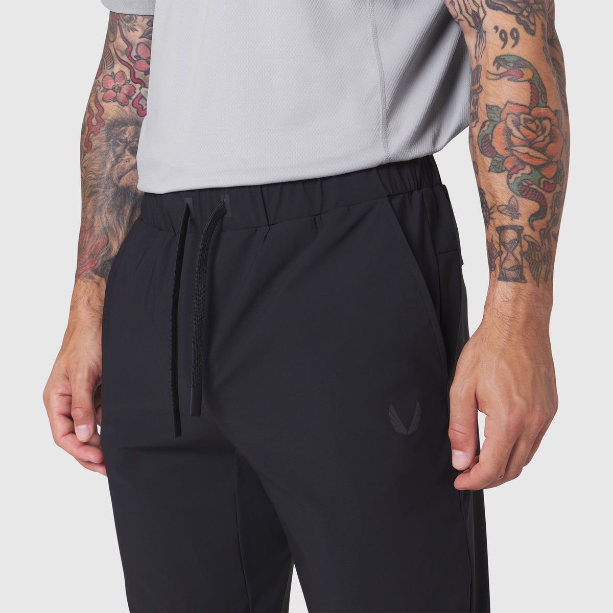 Black TETRA-LITE Training Jogger worn by model, front waist detail view