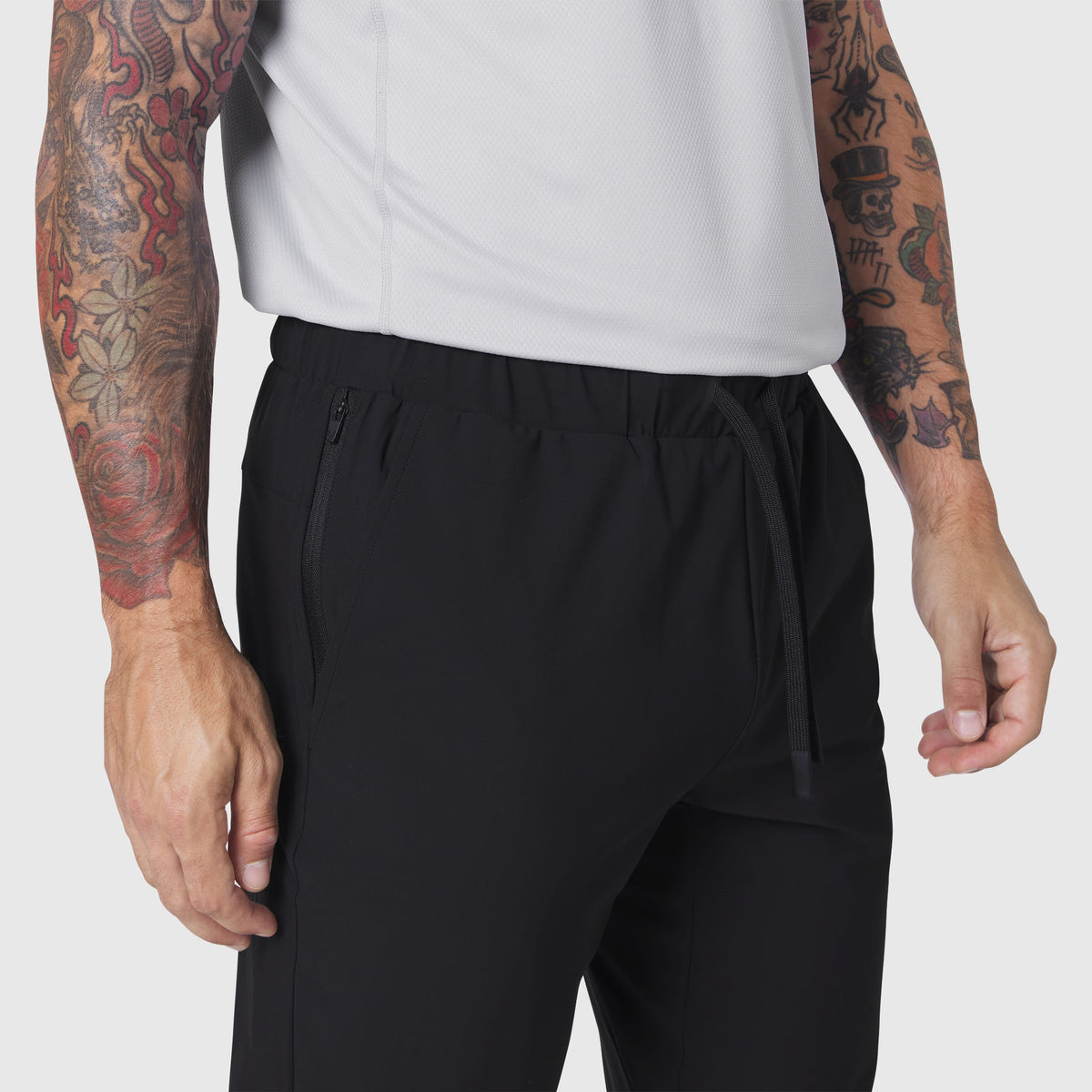 Black TETRA-LITE Training Jogger worn by model, side view detail of waistband and pocket