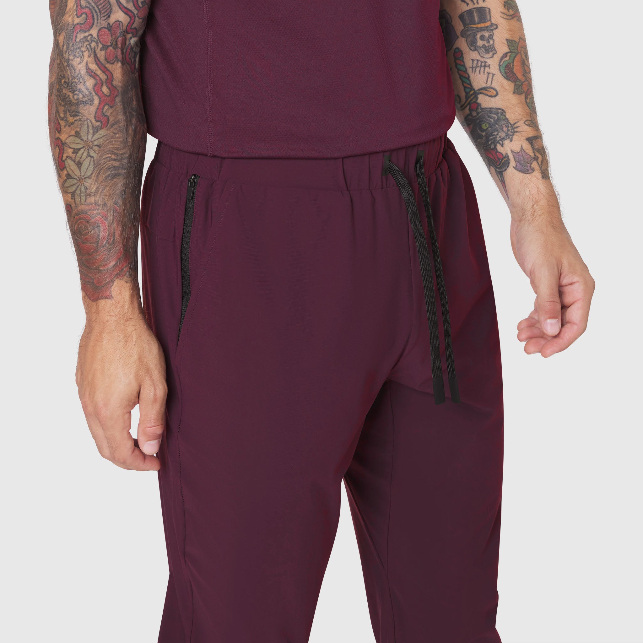 TETRA-LITE® Training Jogger in merlot, worn by model showing front detail with zip pockets