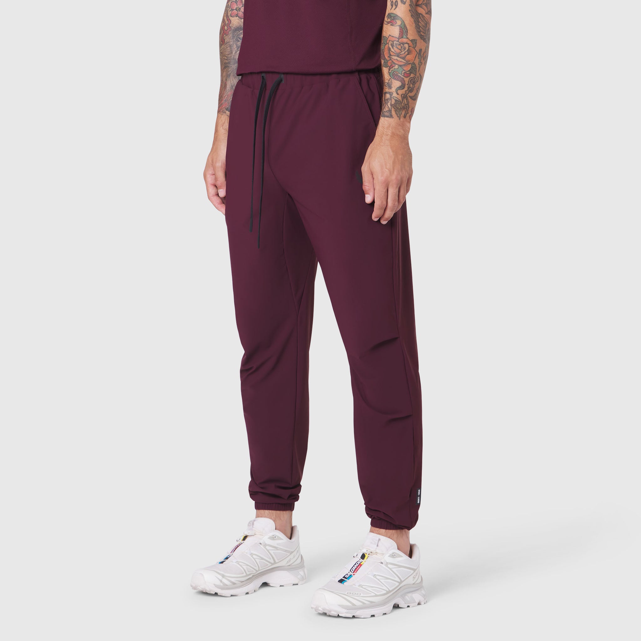 TETRA-LITE® Training Jogger in merlot, worn with white sneakers, front view