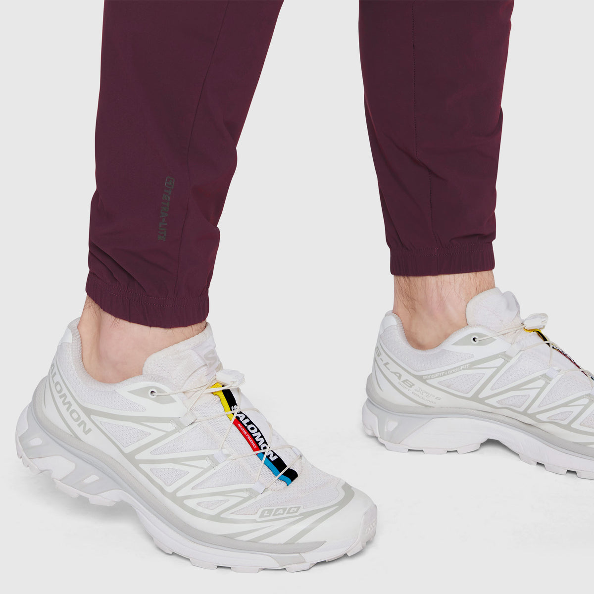 Merlot TETRA-LITE Training Jogger worn with white sneakers, ankle detail view