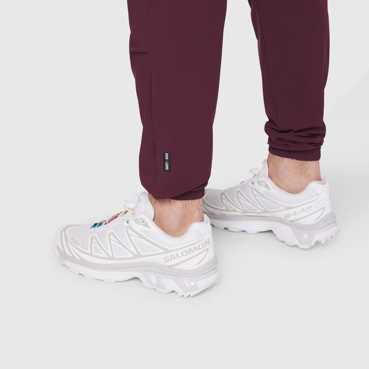 TETRA-LITE Training Jogger in merlot worn with white sneakers, calf detail